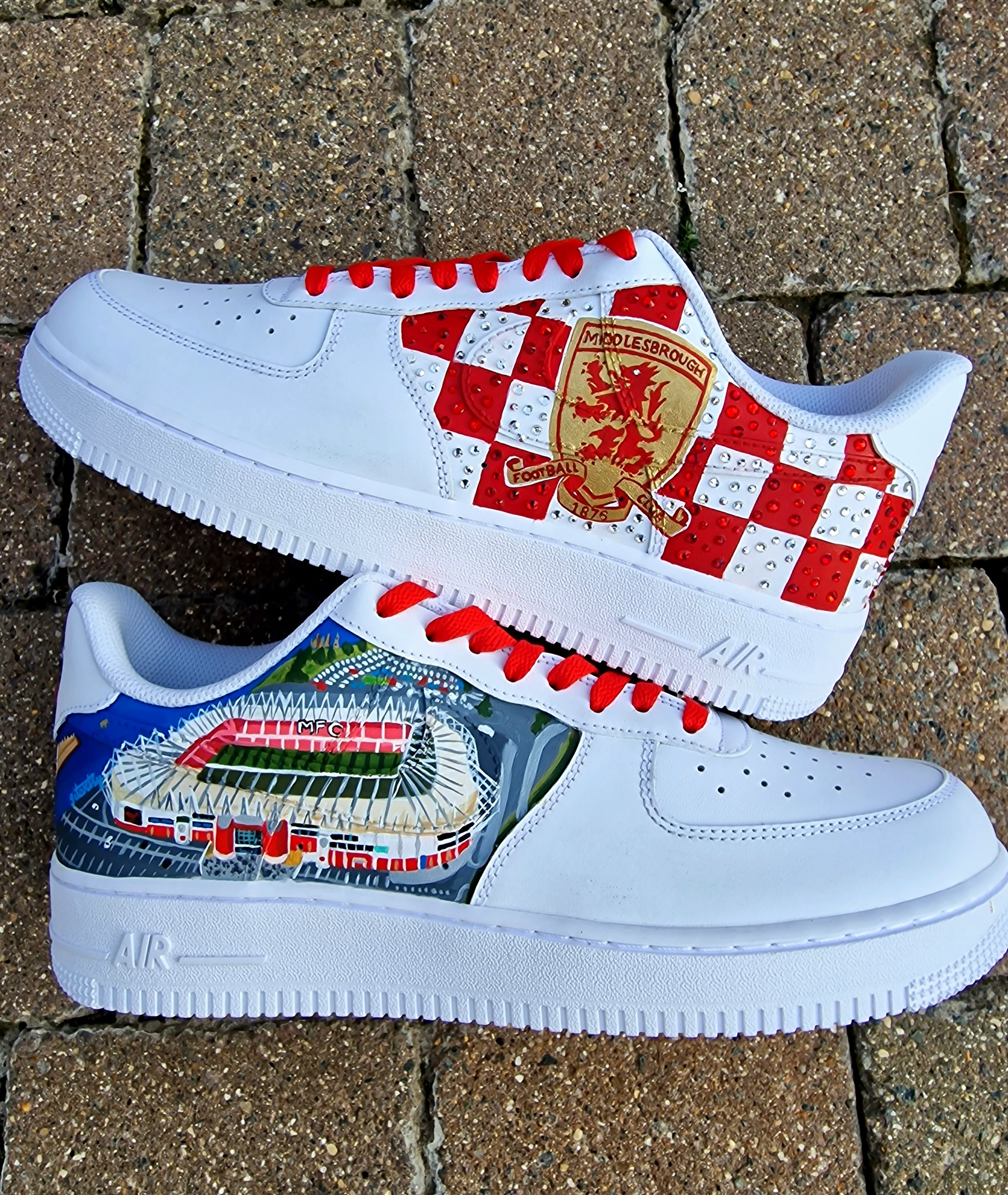Custom hand-painted sneakers featuring Middlesbrough FC crest, red-and-white checkered pattern with stud embellishments, and detailed Riverside Stadium artwork. White base sneakers with red laces, designed by Gitartsy for football fans, sneaker collectors, and Boro supporters.

