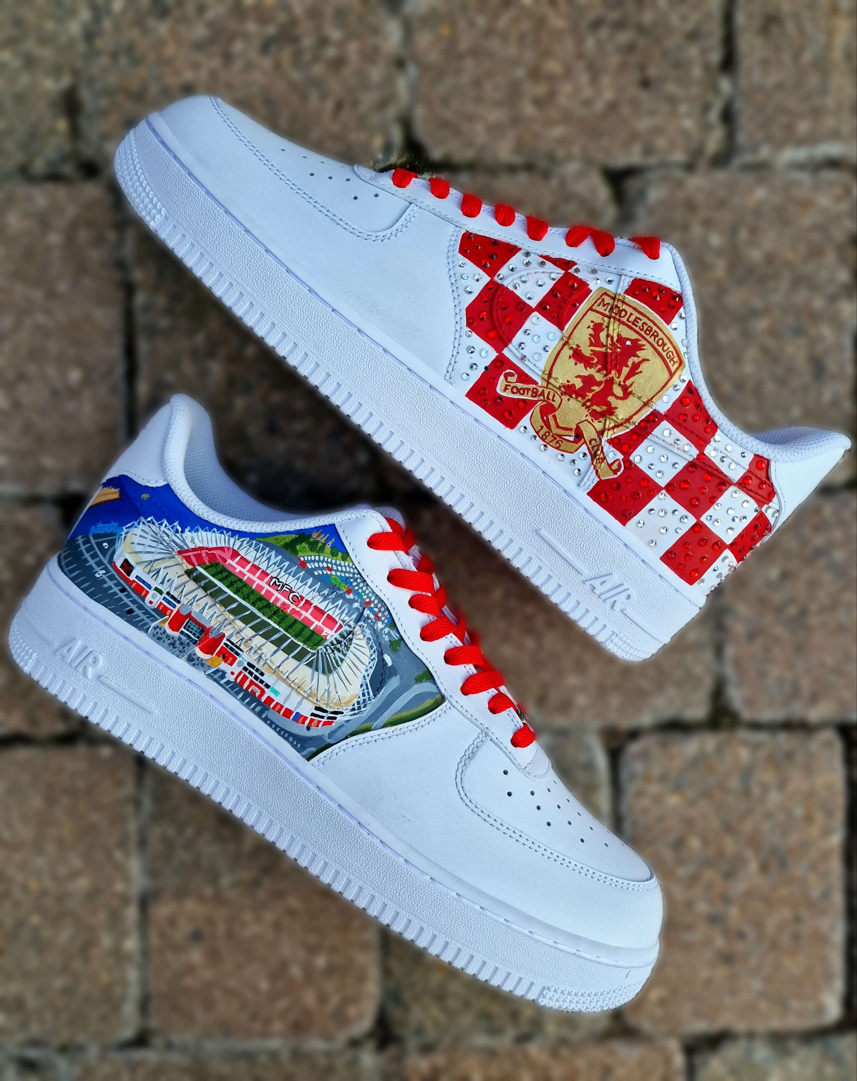 Custom hand-painted sneakers featuring Middlesbrough FC crest, red-and-white checkered pattern with stud embellishments, and detailed Riverside Stadium artwork. White base sneakers with red laces, designed by Gitartsy for football fans, sneaker collectors, and Boro supporters.

