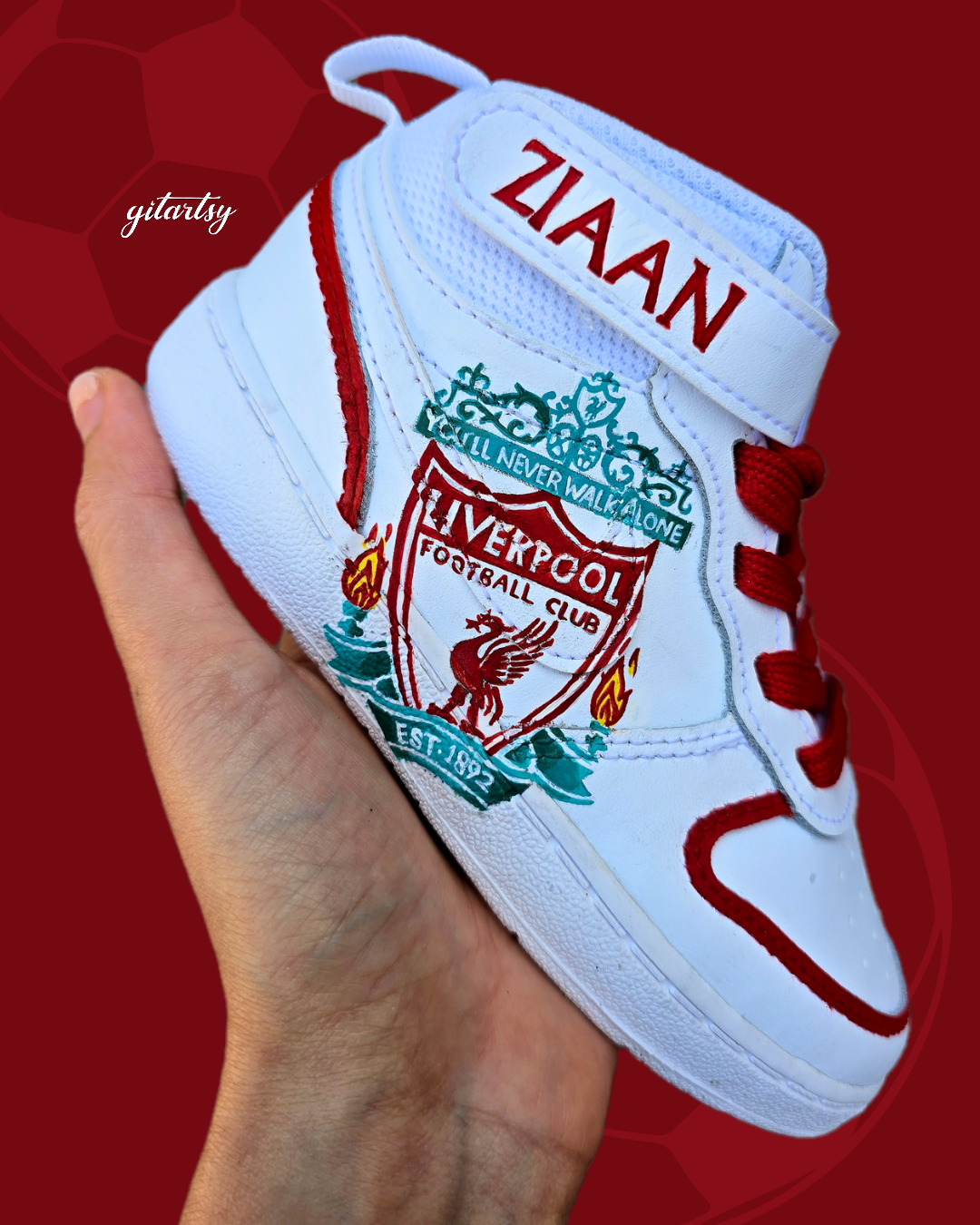 Hand-painted custom baby sneakers featuring a Liverpool FC theme with Mo Salah portrait and club crest. Personalized toddler shoes with red and teal accents, bright red laces, and your child’s name on the Velcro strap. Unique wearable artwork by Gitartsy.

