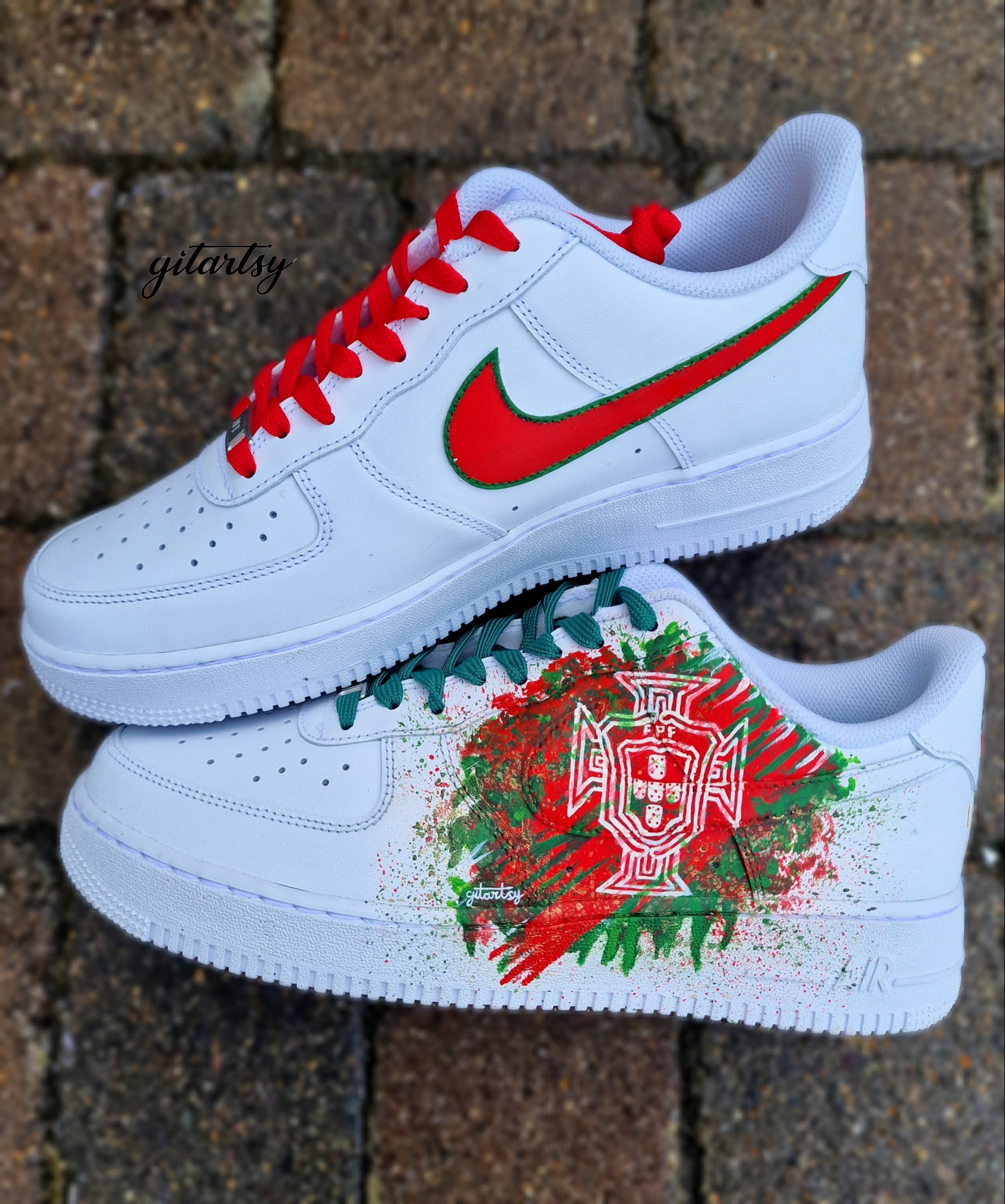 "Custom hand-painted Nike Air Force 1 sneakers featuring Manchester United and Portugal national football team crests, splattered in bold red, green, and black paint with unique details, crafted by Gitartsy."

