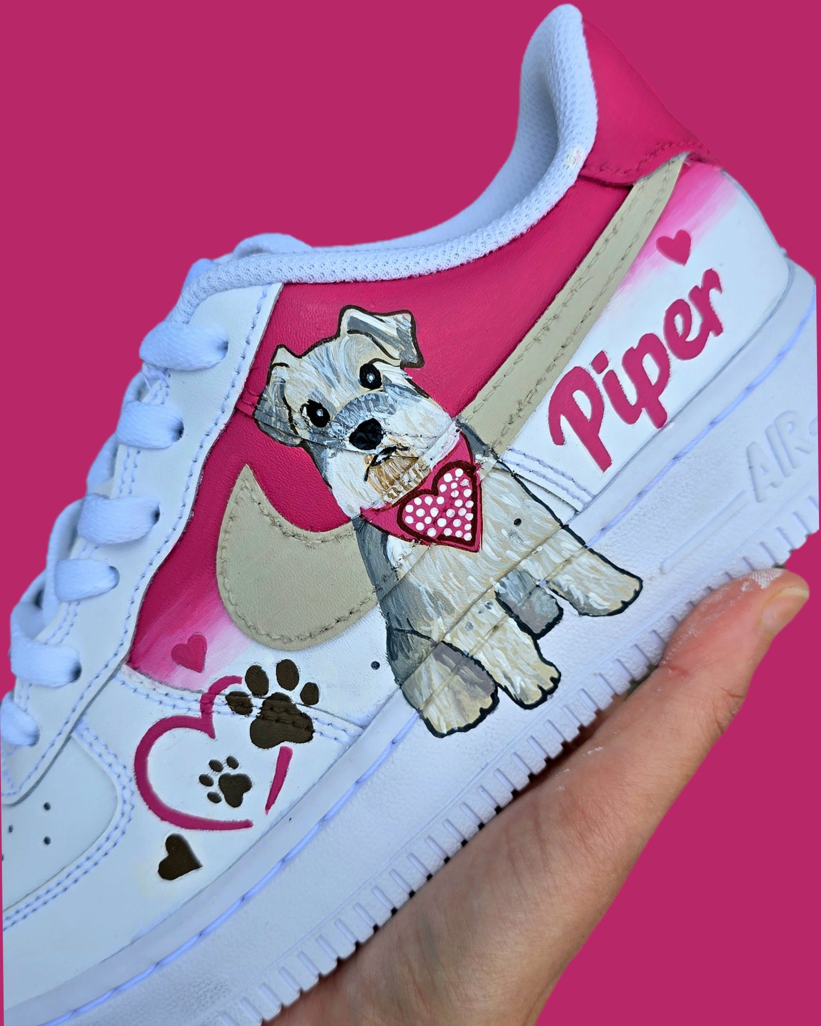 Hand-painted Nike Air Force 1 custom sneakers featuring a realistic pet portrait of “Piper” the dog 🐾, pink or taupe background, heart ❤️ and paw print accents, and personalised name detail, created by Gitartsy.

