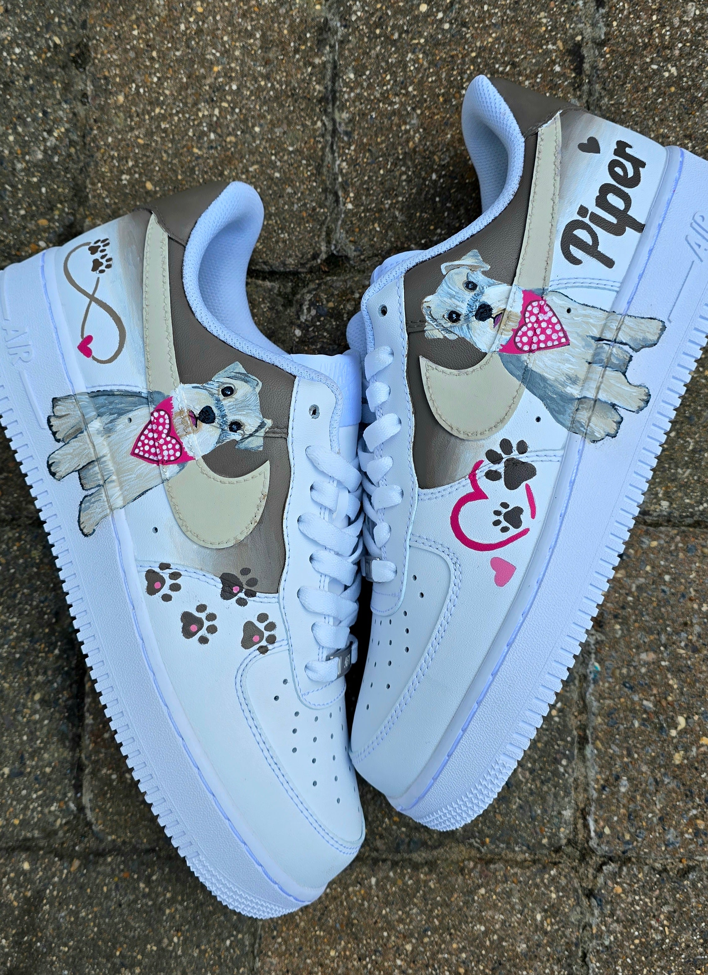 Hand-painted Nike Air Force 1 custom sneakers featuring a realistic pet portrait of “Piper” the dog 🐾, pink or taupe background, heart ❤️ and paw print accents, and personalised name detail, created by Gitartsy.

