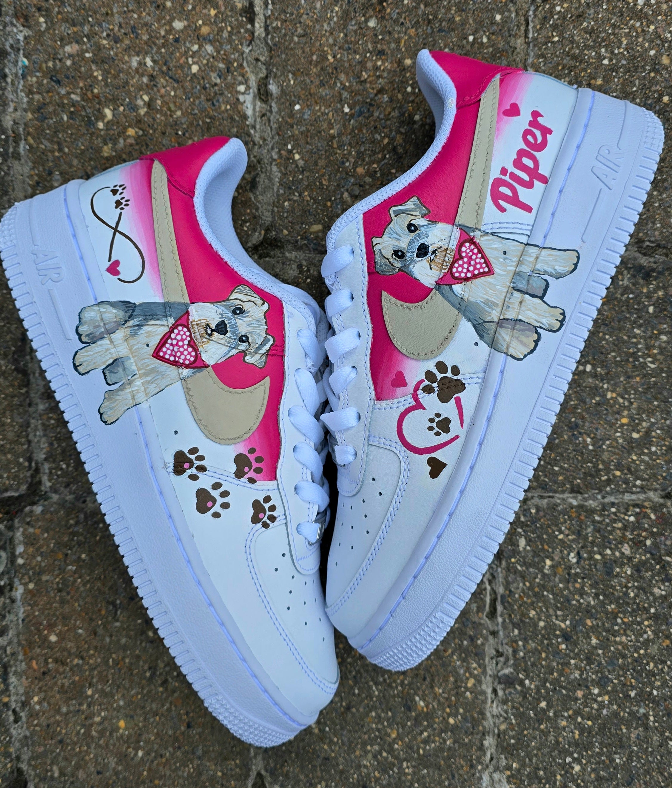 Hand-painted Nike Air Force 1 custom sneakers featuring a realistic pet portrait of “Piper” the dog 🐾, pink or taupe background, heart ❤️ and paw print accents, and personalised name detail, created by Gitartsy.

