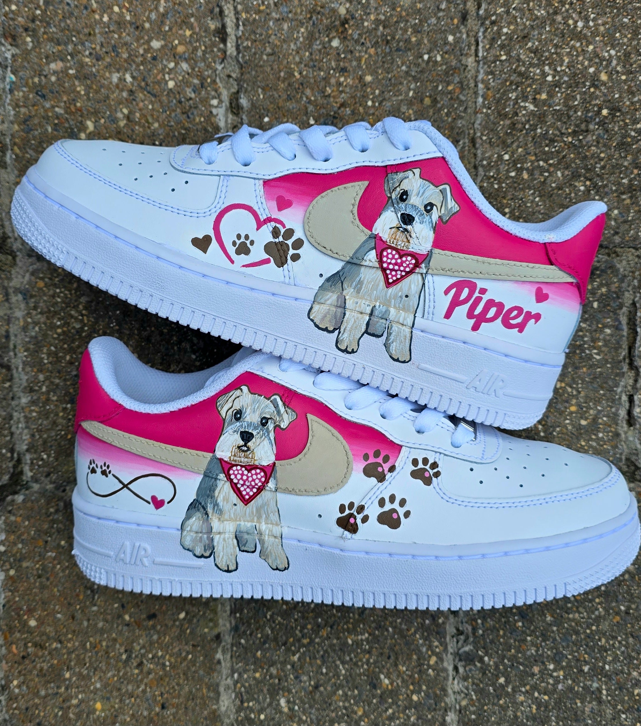 Hand-painted Nike Air Force 1 custom sneakers featuring a realistic pet portrait of “Piper” the dog 🐾, pink or taupe background, heart ❤️ and paw print accents, and personalised name detail, created by Gitartsy.

