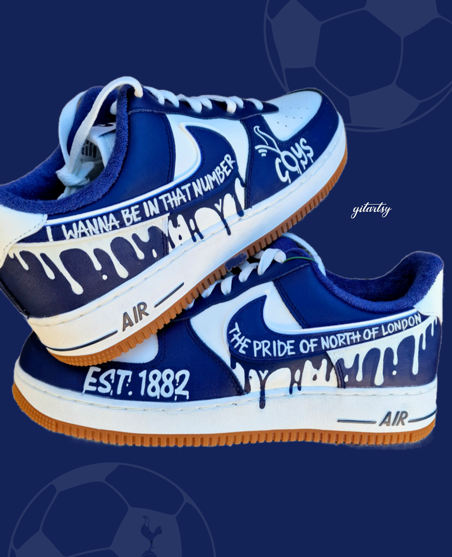 Custom hand-painted Nike Air Force 1 sneakers in navy and white featuring Tottenham Hotspur-inspired artwork, paint drip design, and fan chants including “COYS”, “The Pride of North of London”, “I Wanna Be In That Number”, and “Est. 1882”, created by Gitartsy with premium leather paint and sealing for durability and vibrancy.

