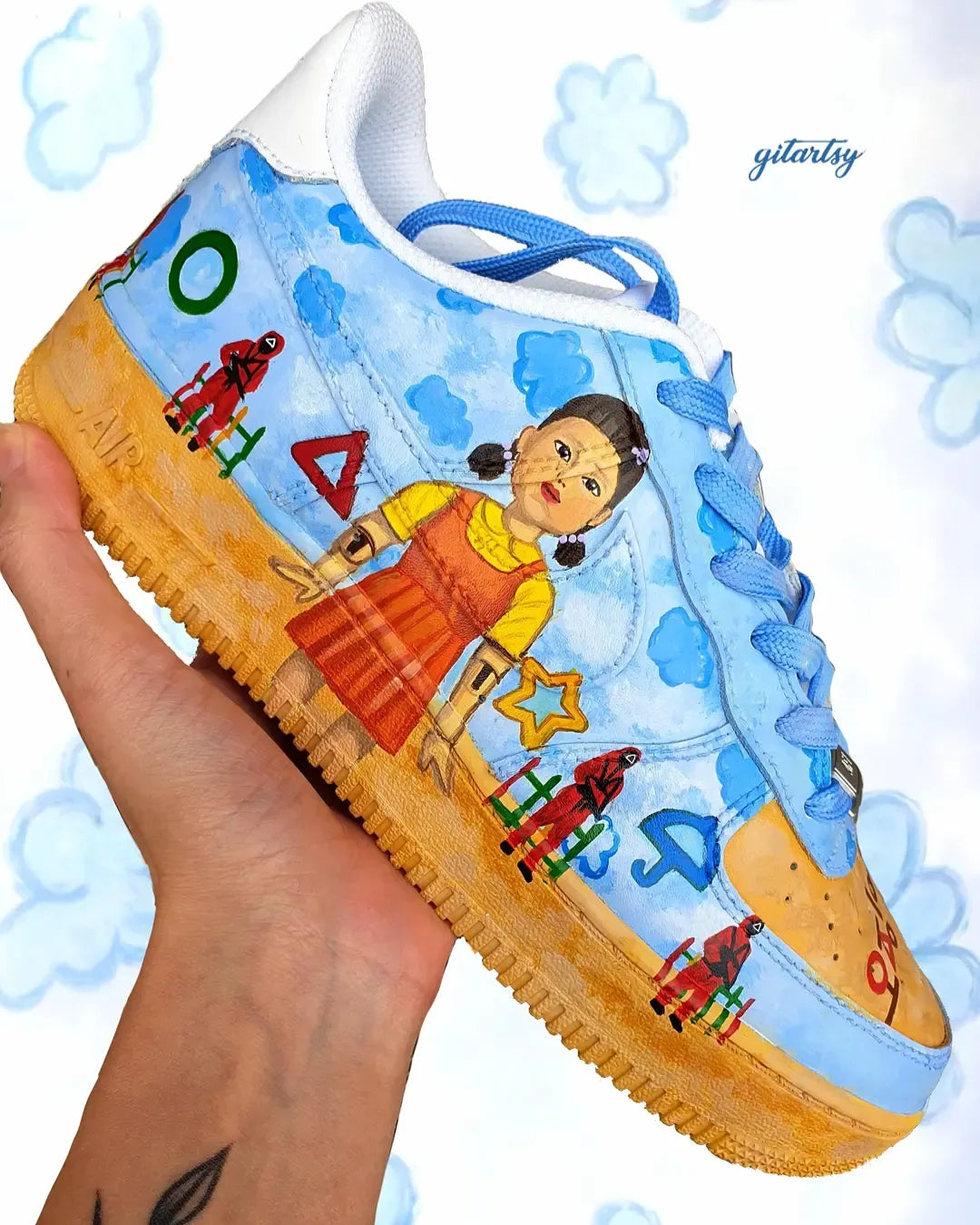 Netflix series Squid Game doll, guards and icons painted on Nike AF1 sneakers with detailed blue sky background - zoomed in view