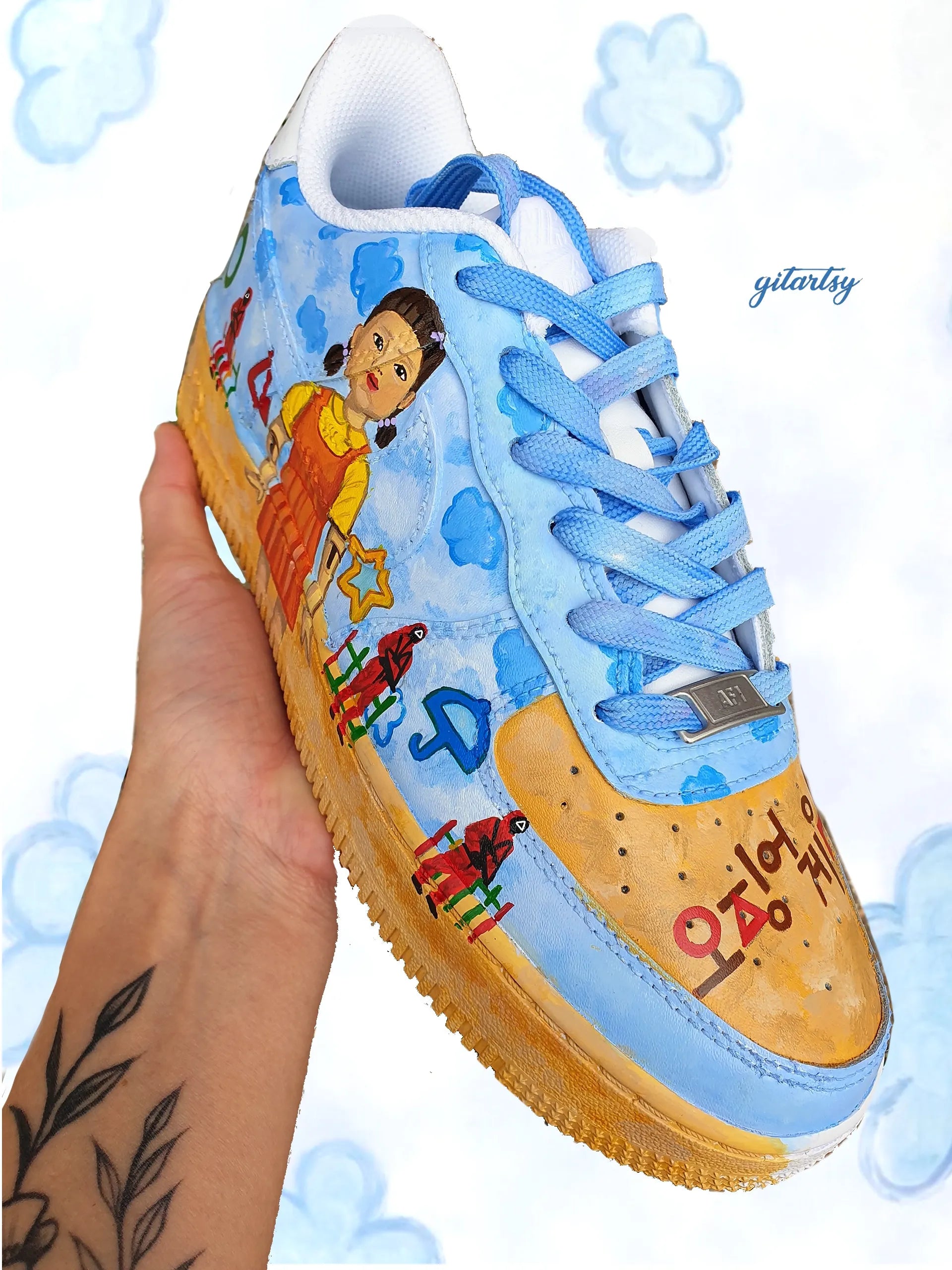 Netflix series Squid Game doll, guards and icons painted on Nike AF1 sneakers with detailed blue sky background - zoomed in view