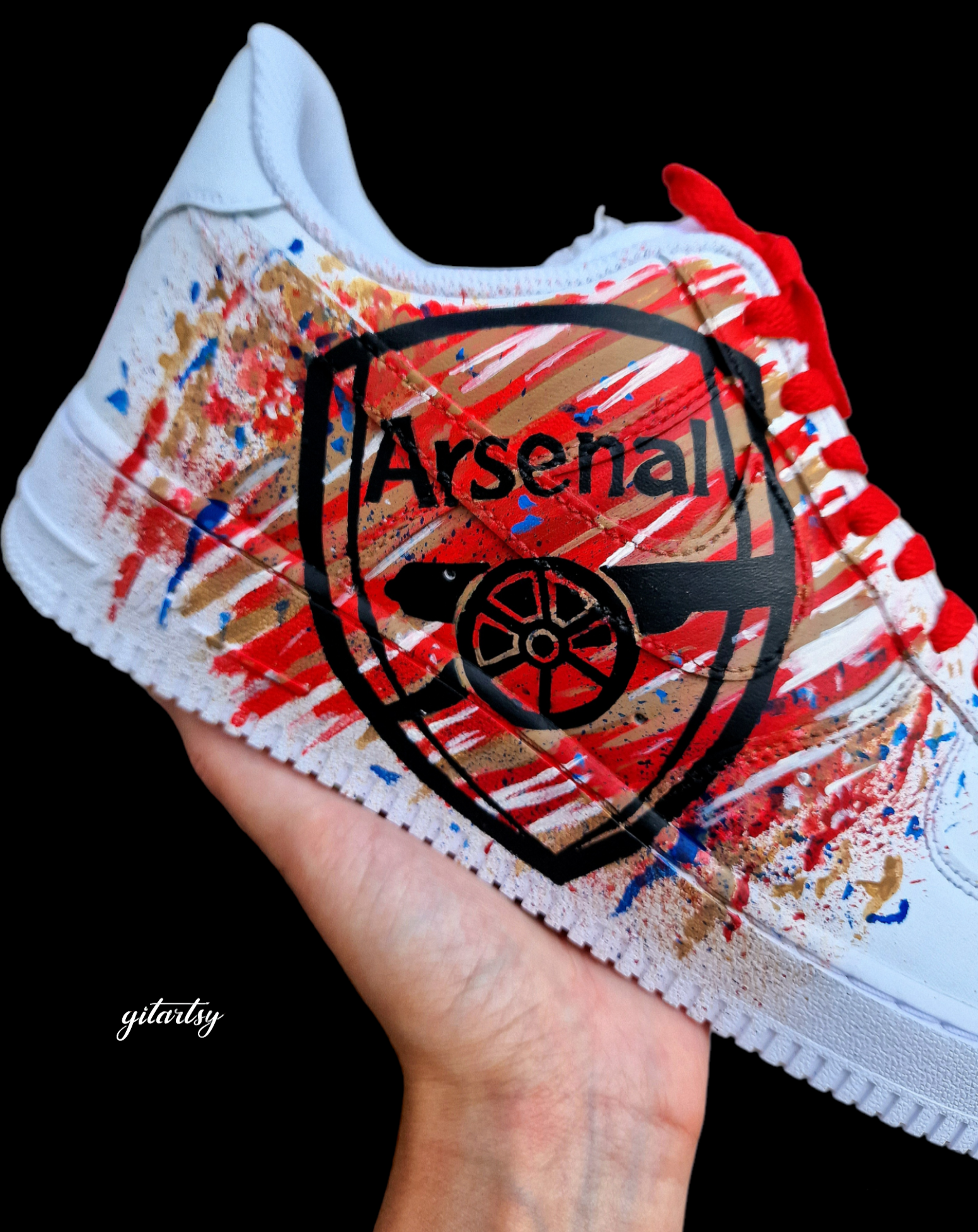 Hand-painted custom Nike Air Force 1 sneakers featuring David Raya in Arsenal goalkeeper kit, Arsenal crest, Spanish flag and colors, vibrant football-inspired splatter artwork, crafted by Gitartsy.

