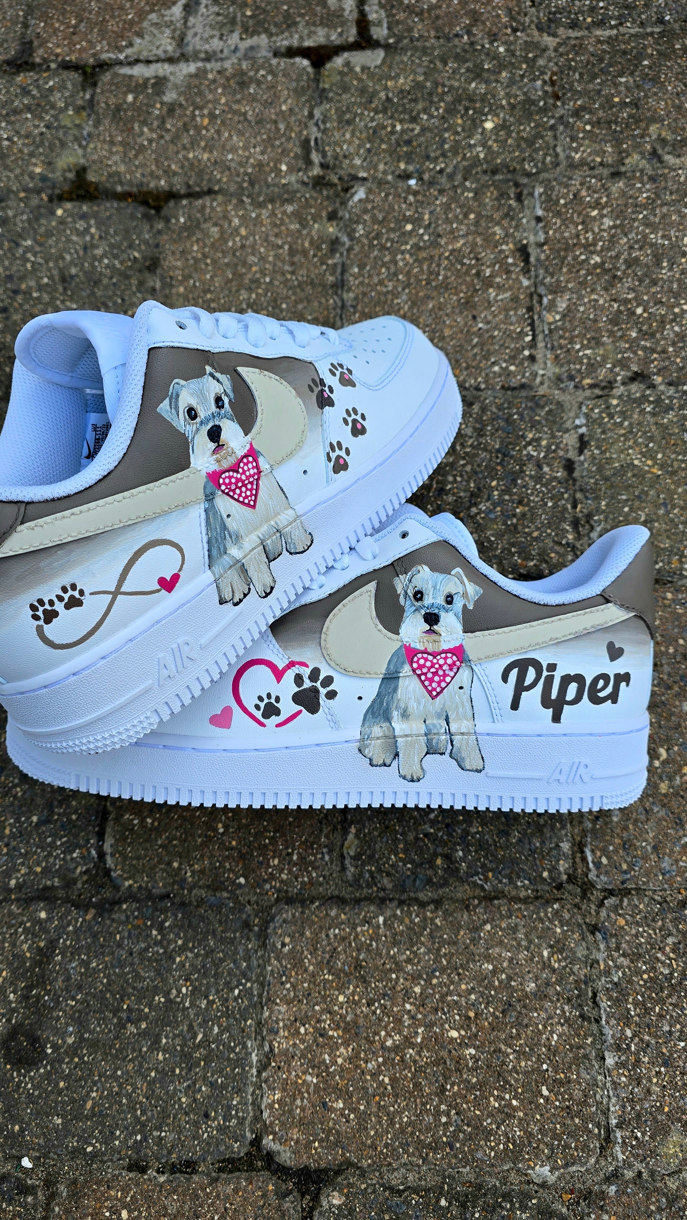 Hand-painted Nike Air Force 1 custom sneakers featuring a realistic pet portrait of “Piper” the dog 🐾, pink or taupe background, heart ❤️ and paw print accents, and personalised name detail, created by Gitartsy.

