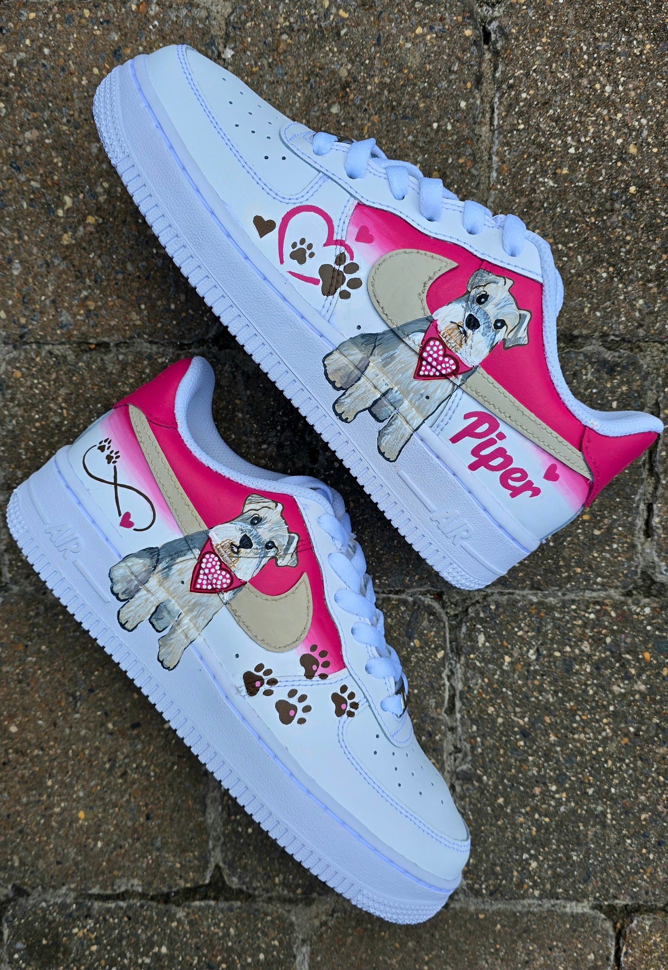 Hand-painted Nike Air Force 1 custom sneakers featuring a realistic pet portrait of “Piper” the dog 🐾, pink or taupe background, heart ❤️ and paw print accents, and personalised name detail, created by Gitartsy.

