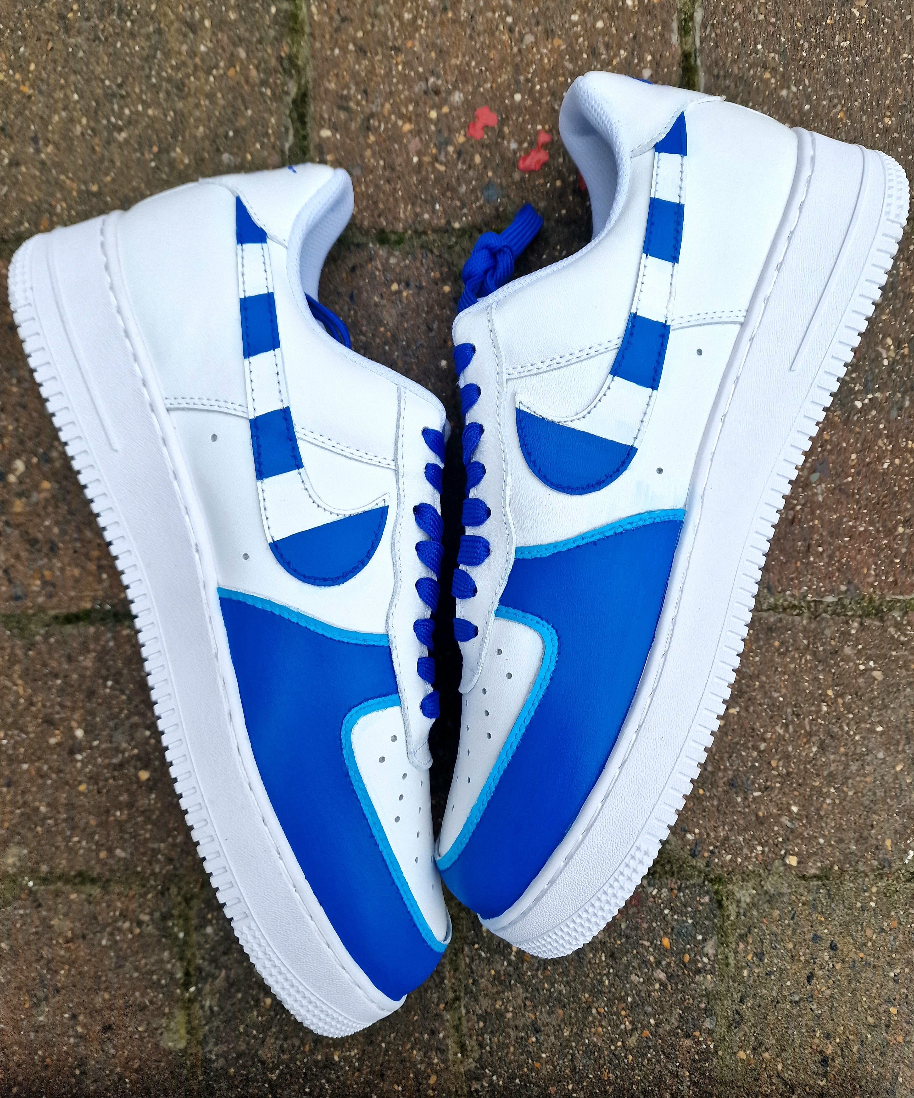 Custom FC Porto Nike Air Force 1 sneakers designed for football fans, featuring hand-painted artwork with the official club crest, blue and white color scheme, dragon mascot, and player number detailing. These one-of-a-kind shoes are crafted using authentic Nike AF1s and painted with weather-resistant leather paints. Perfect for sports lovers and collectors, combining comfort with team spirit.

