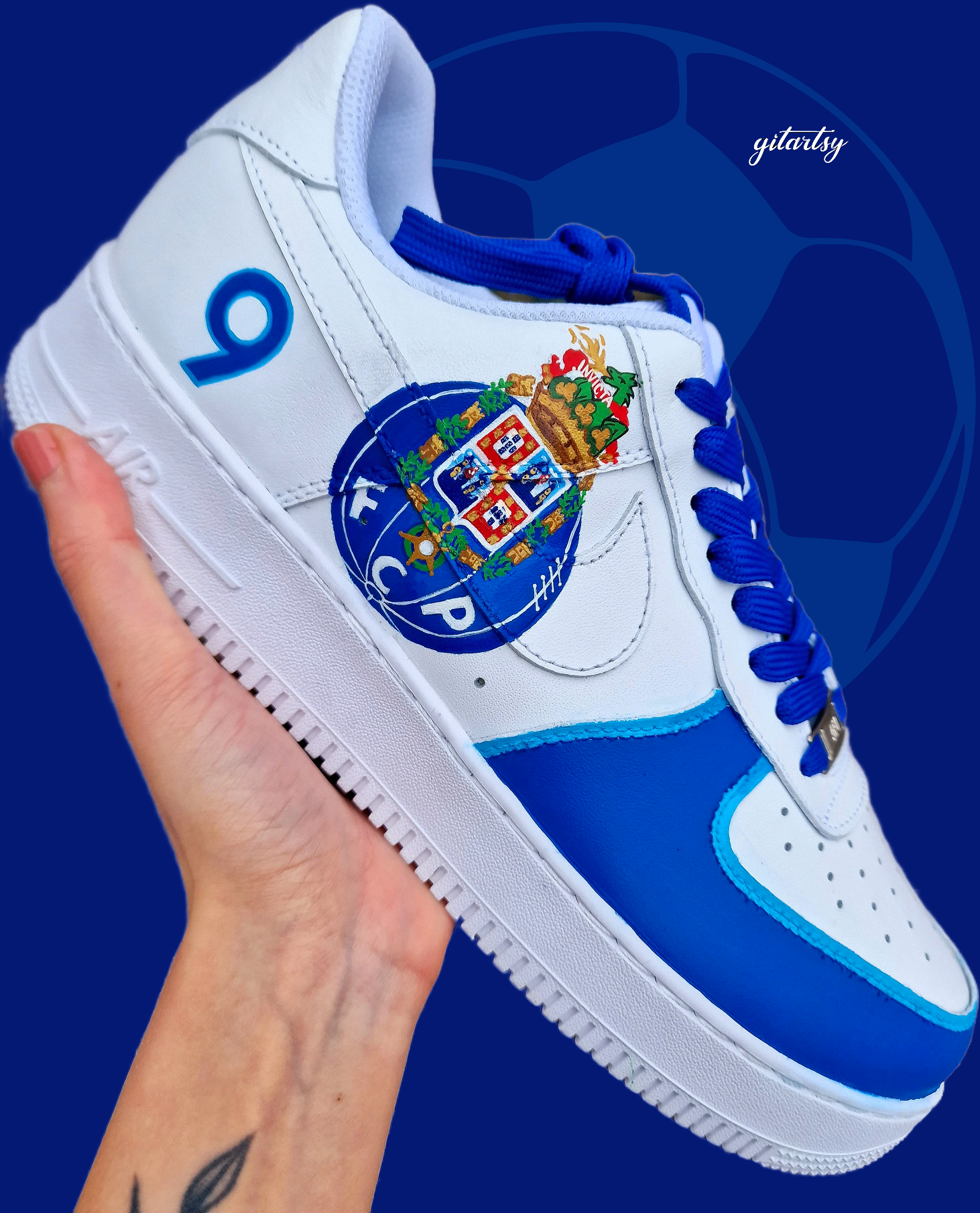 Custom FC Porto Nike Air Force 1 sneakers designed for football fans, featuring hand-painted artwork with the official club crest, blue and white color scheme, dragon mascot, and player number detailing. These one-of-a-kind shoes are crafted using authentic Nike AF1s and painted with weather-resistant leather paints. Perfect for sports lovers and collectors, combining comfort with team spirit.

