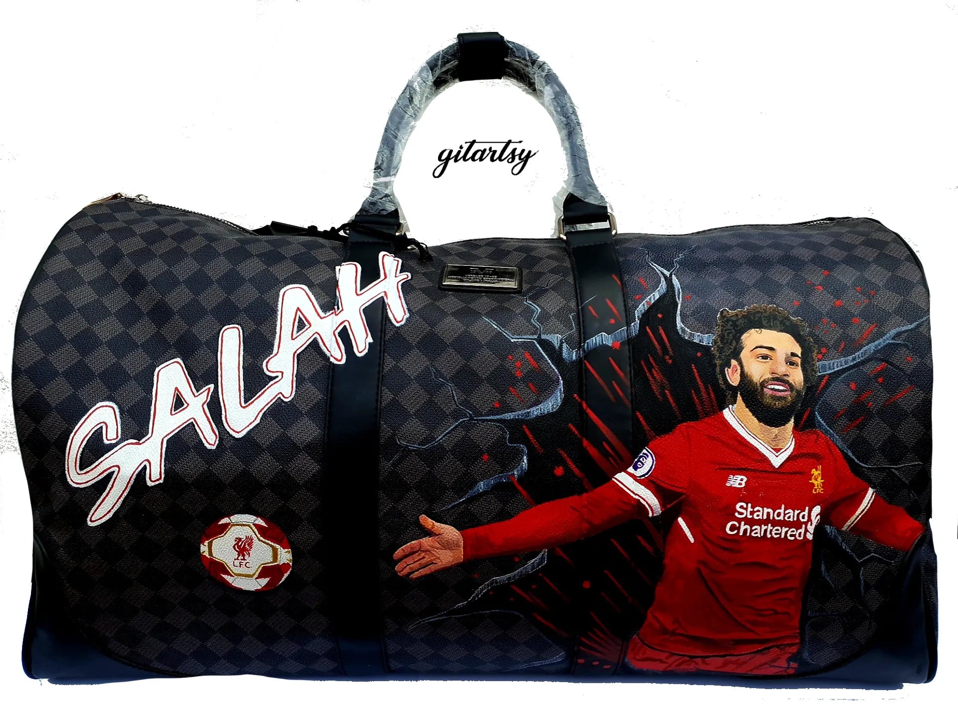 Footballer Mohamed Salah from Liverpool LFC's portrait hand painted on a large duffle bag with his name and a football