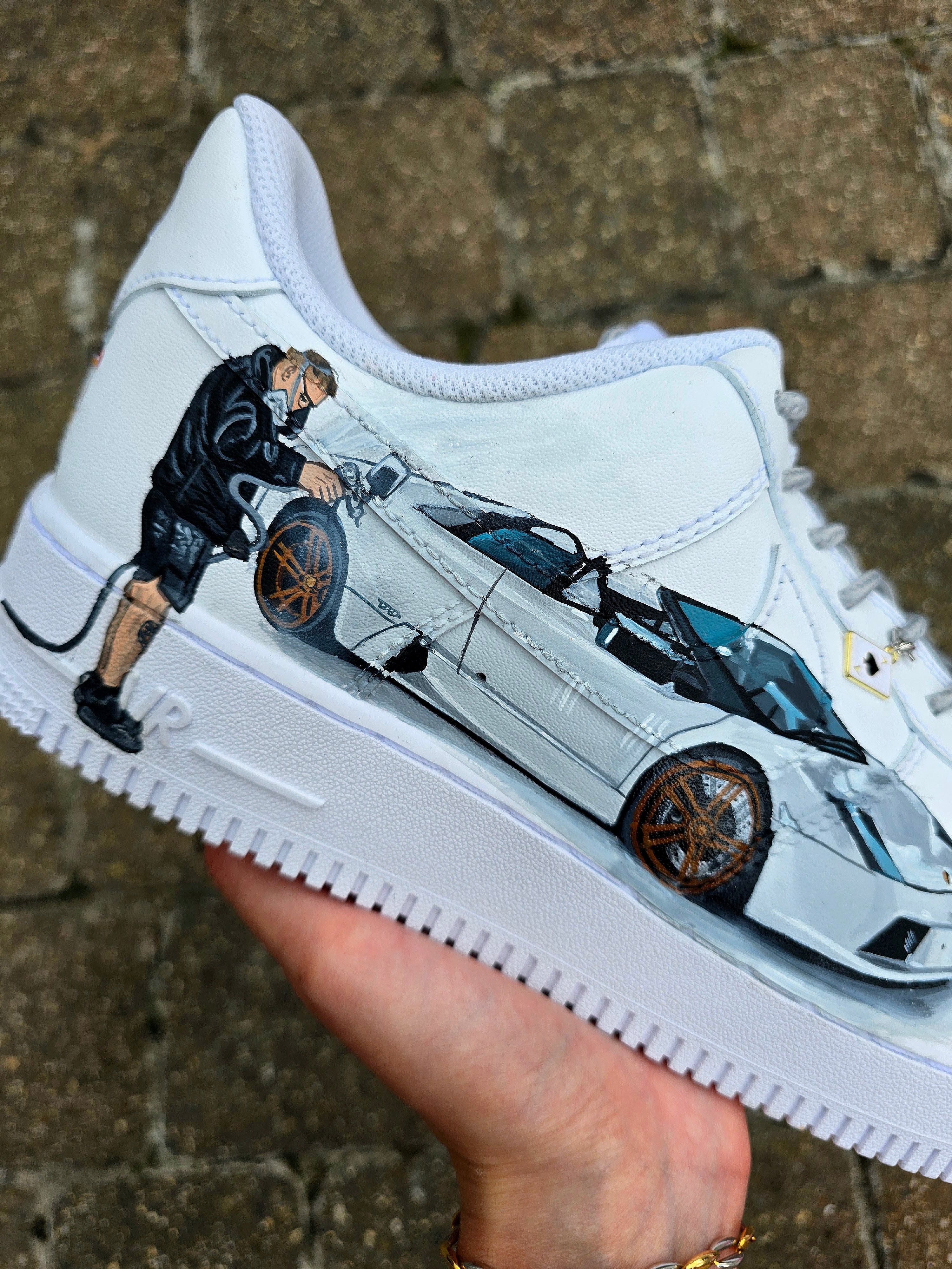 Custom hand-painted Nike Air Force 1 sneakers featuring a Lamborghini-inspired design 🏎️ and spray painter artwork 🎨. Created by Gitartsy using premium leather paints, sealed for durability, and fully customisable with personal details such as car models, colors, and text. Perfect for car enthusiasts 🚗, sneaker collectors 👟, and streetwear lovers seeking one-of-a-kind footwear.

