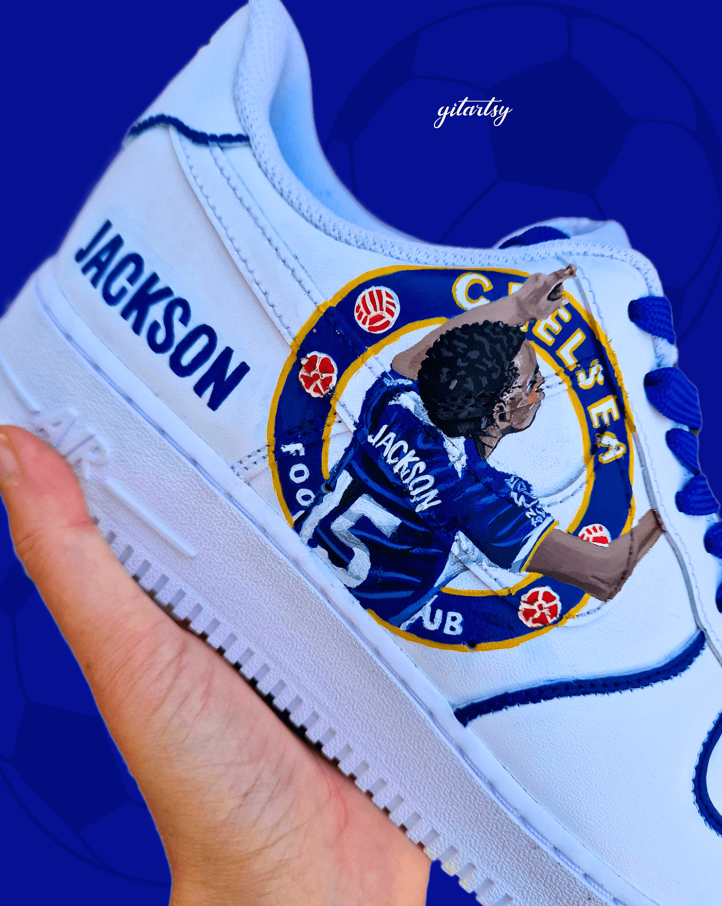 Custom hand-painted white sneakers featuring Chelsea FC’s Nicolas Jackson in vivid blue match kit, complete with the club badge and Senegal flag-inspired Nike swoosh. Designed by Gitartsy, the artwork includes realistic player portraits, fine detailing, and premium waterproof paint, making these shoes a perfect blend of fashion and football art.

