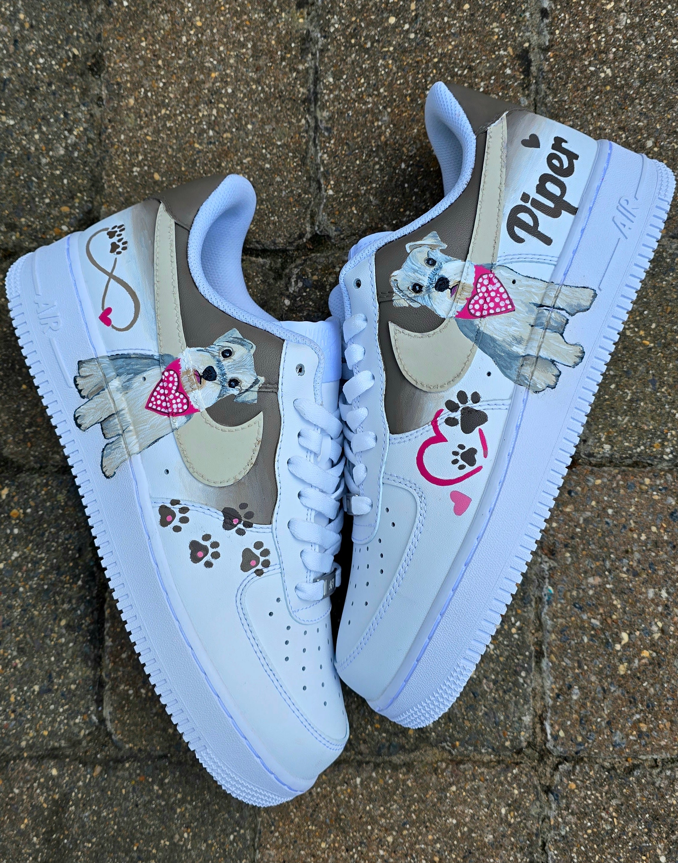 Hand-painted Nike Air Force 1 custom sneakers featuring a realistic pet portrait of “Piper” the dog 🐾, pink or taupe background, heart ❤️ and paw print accents, and personalised name detail, created by Gitartsy.


