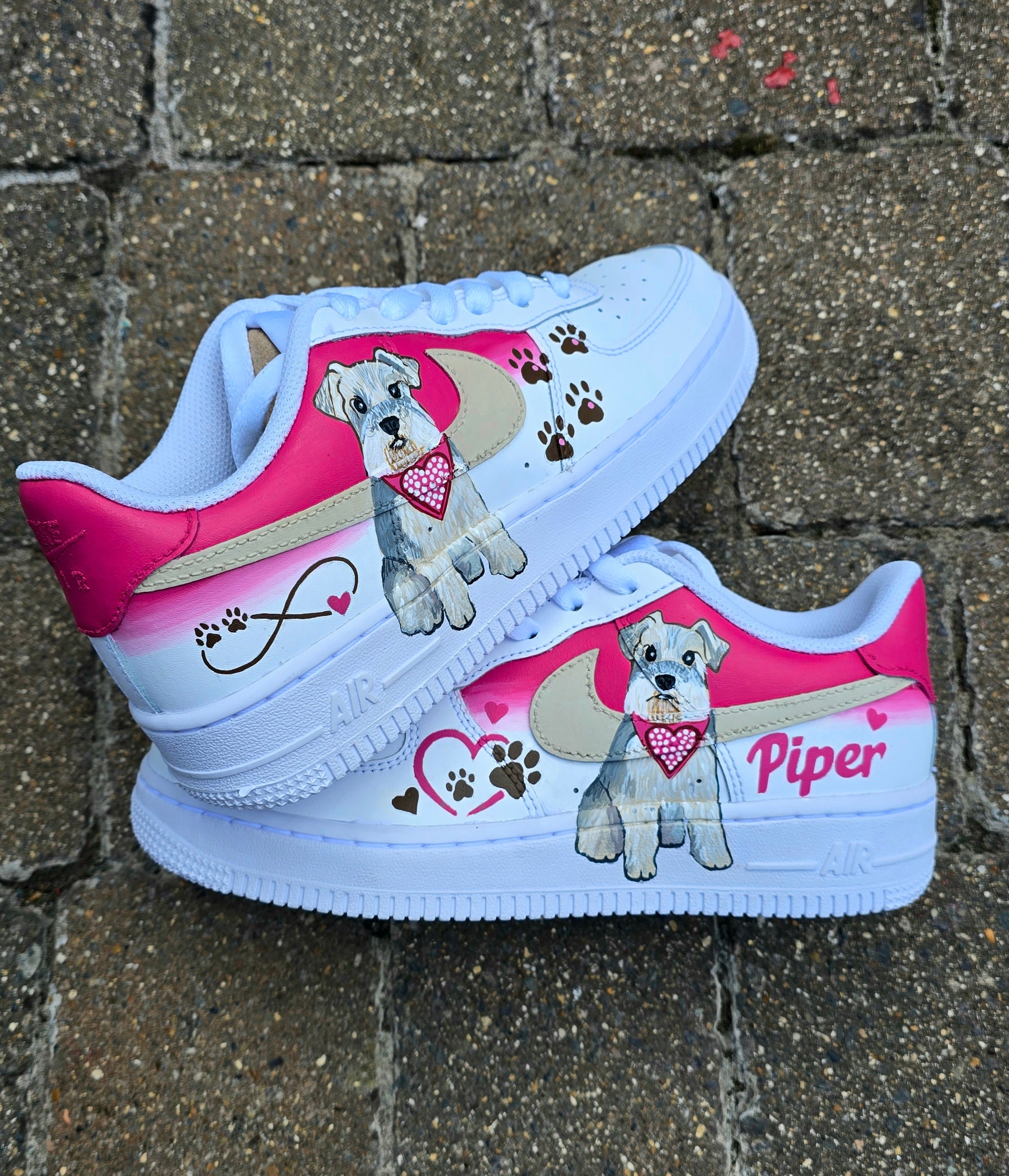 Hand-painted Nike Air Force 1 custom sneakers featuring a realistic pet portrait of “Piper” the dog 🐾, pink or taupe background, heart ❤️ and paw print accents, and personalised name detail, created by Gitartsy.

