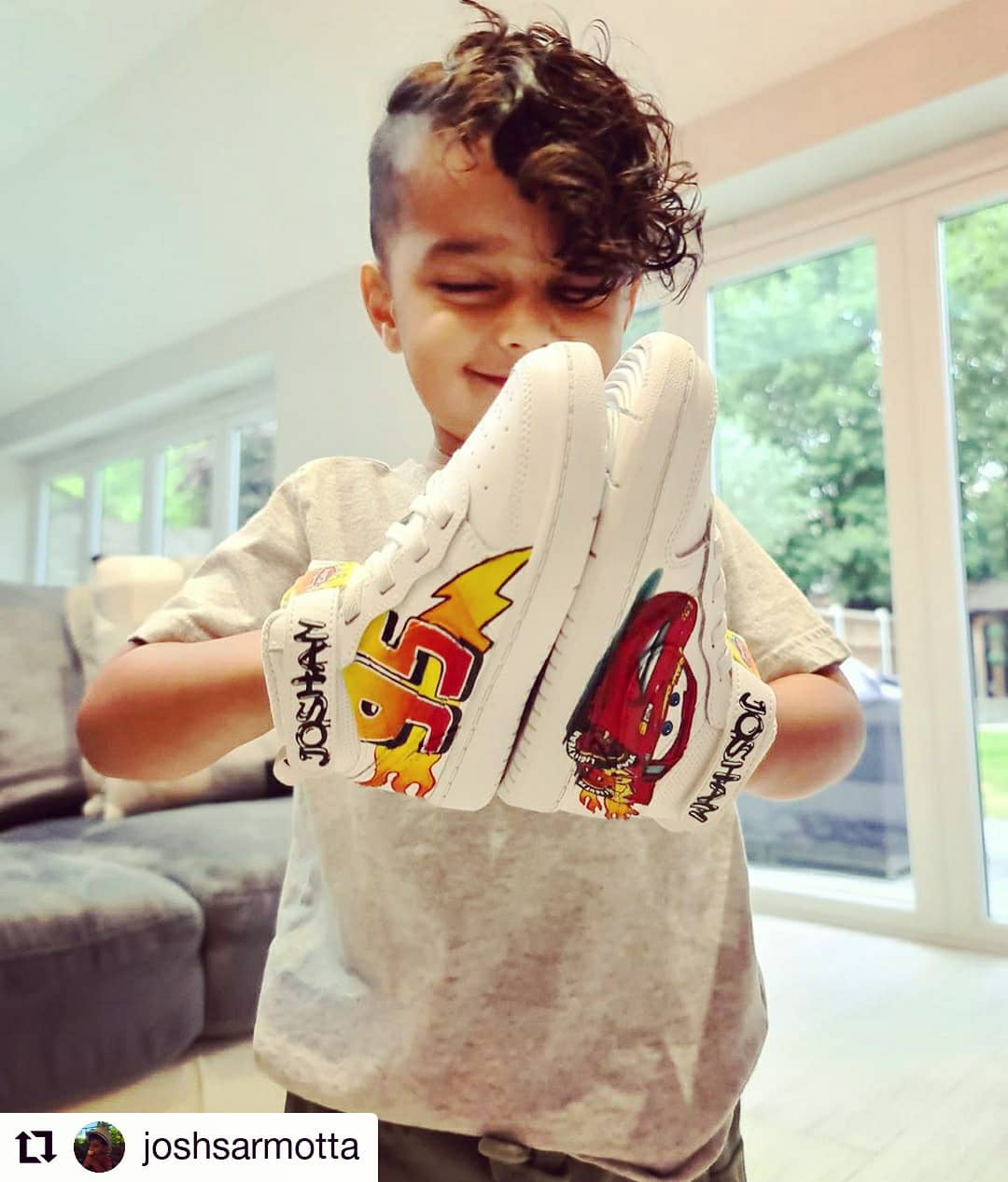 Happy child client holding his custom sneakers - cars theme nike af1