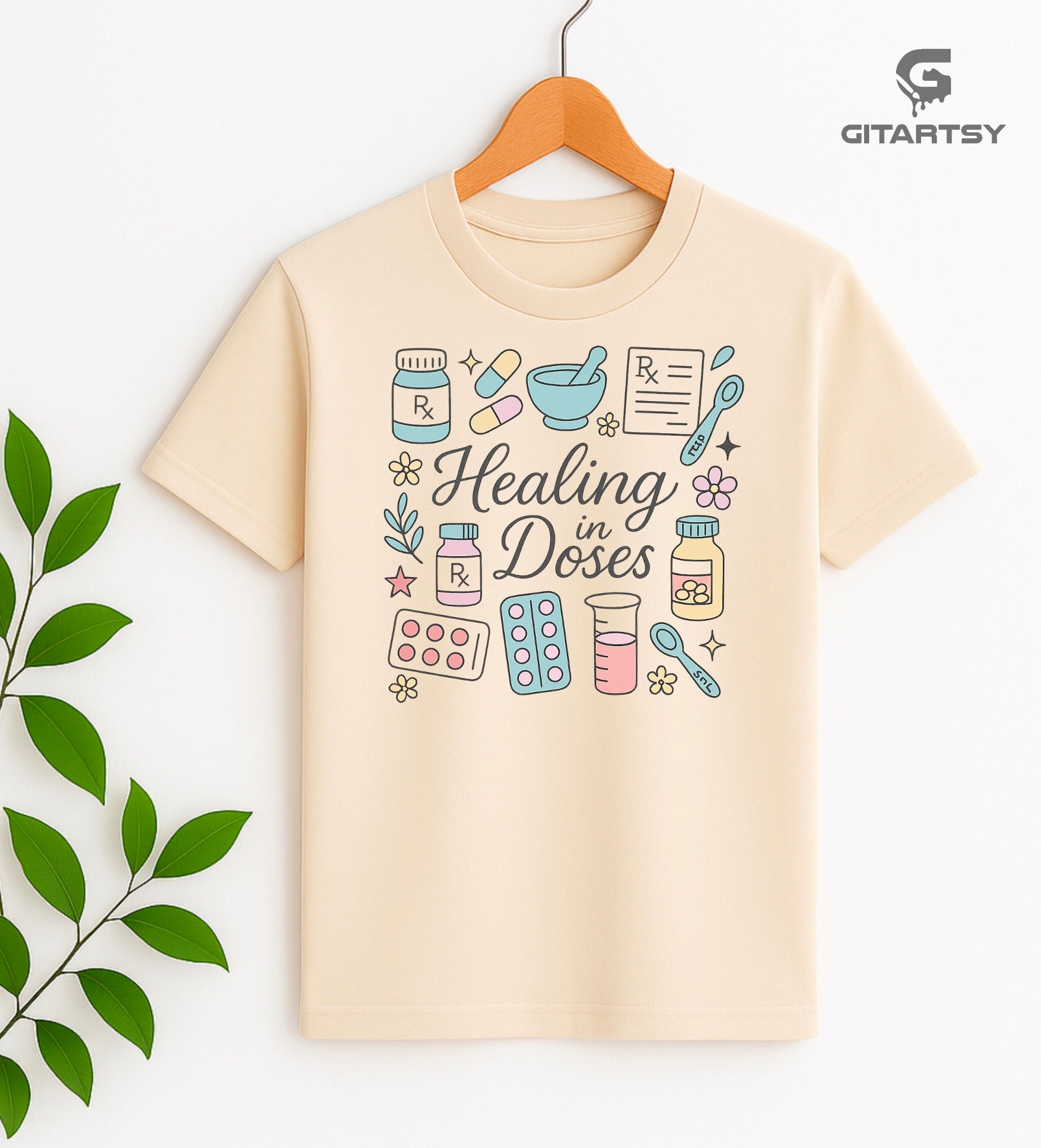 T-shirt with the phrase "Healing in Doses" featuring pastel illustrations of medical elements such as pills, prescription bottles, RX sheets, thermometers, and beakers – ideal for healthcare professionals and pharmacy lovers.