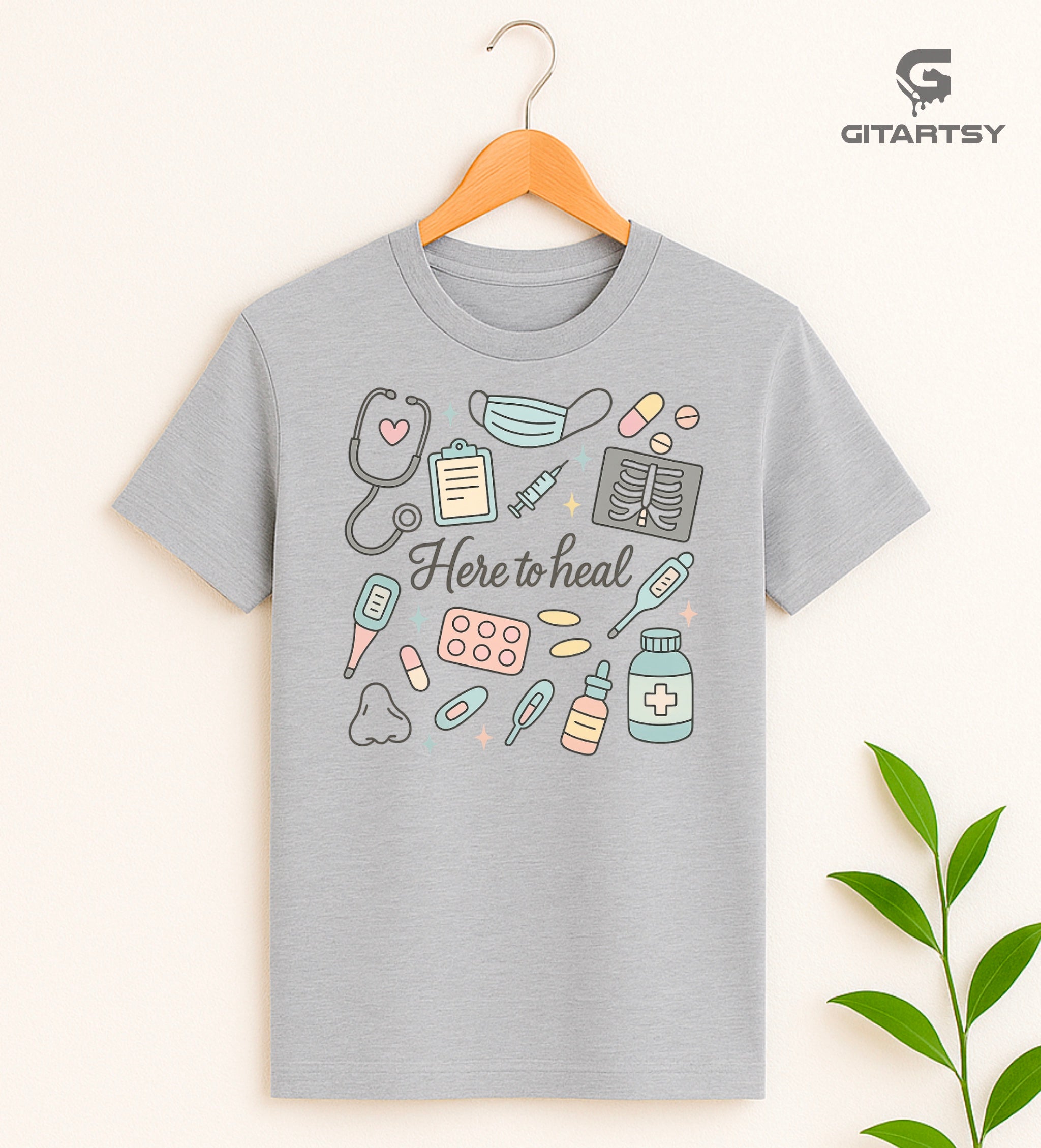 T-shirt with pastel medical illustrations and the phrase “Here to Heal” – ideal for doctors, nurses, and healthcare professionals - gray