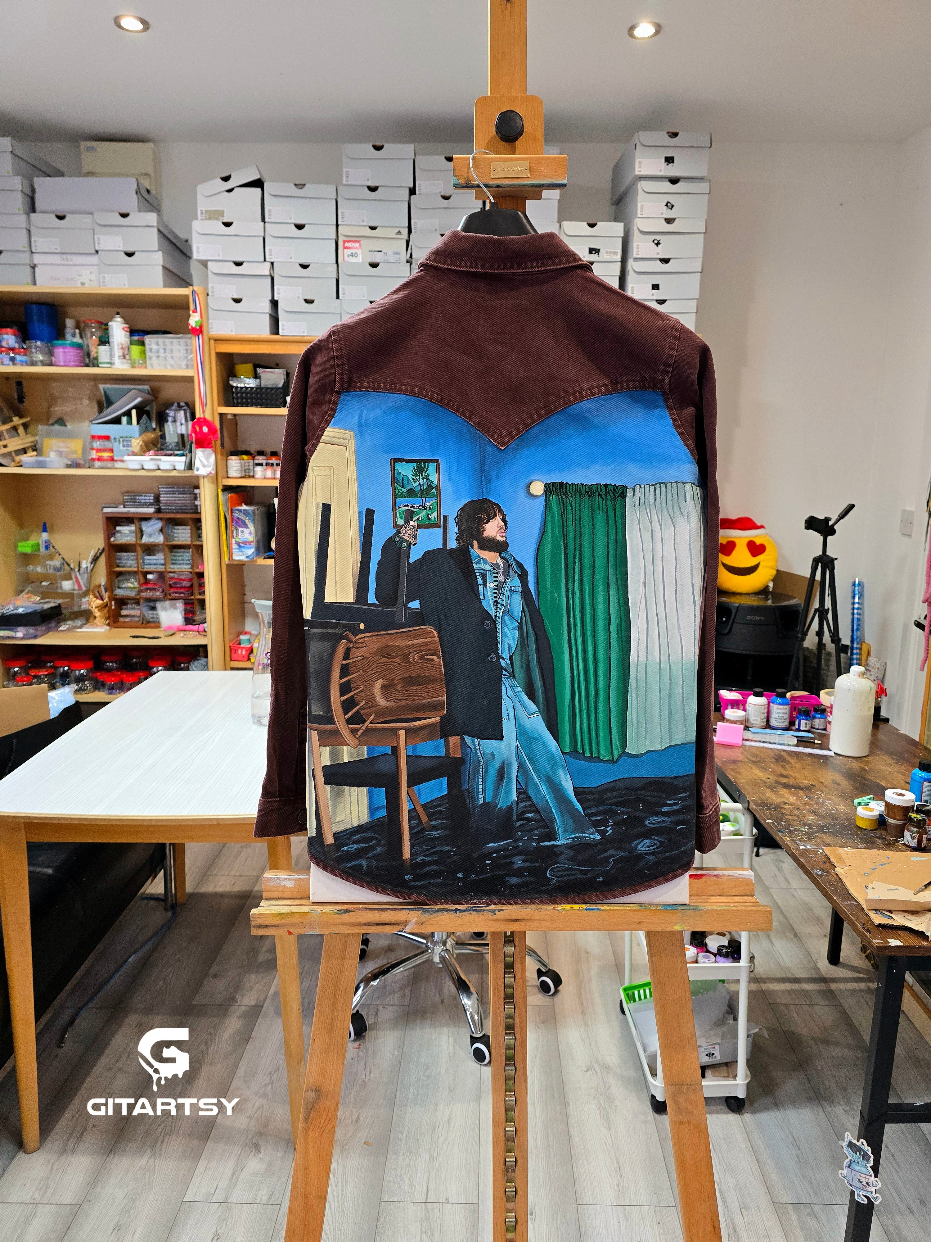 James Arthur Singer Hand Painted Denim Jacket featuring a detailed back artwork of James Arthur in a vibrant indoor scene, painted on a burgundy denim jacket with “Pisces” embroidered on the front, created by Gitartsy using high-quality fabric paints for long-lasting wear.


