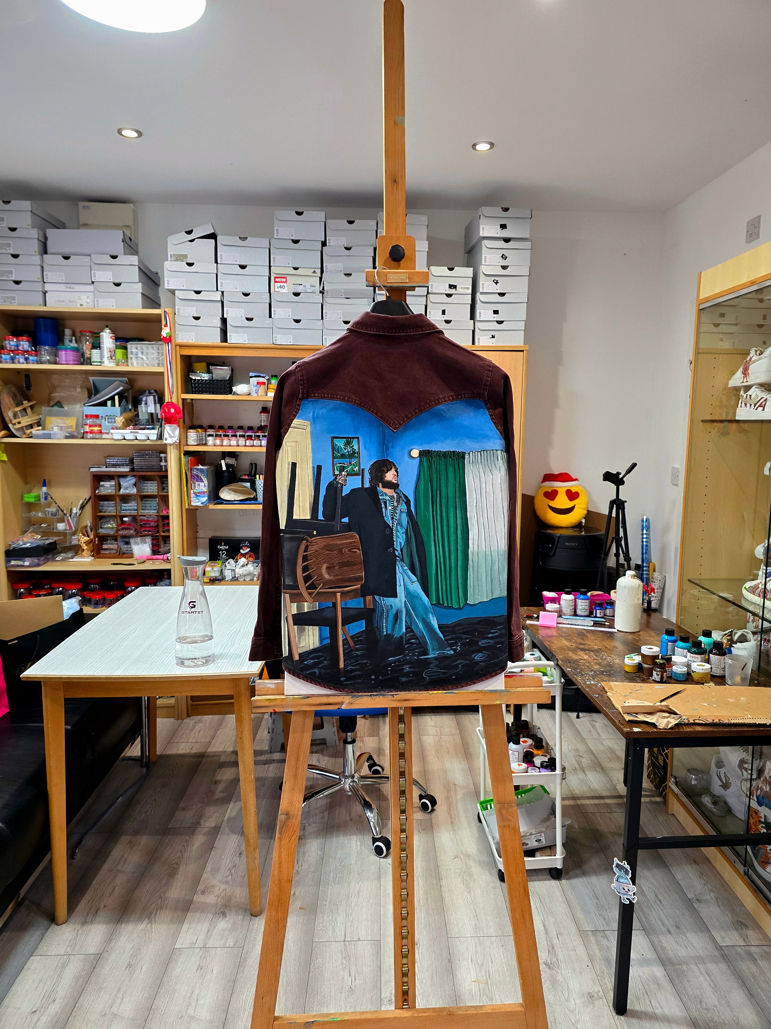 James Arthur Singer Hand Painted Denim Jacket featuring a detailed back artwork of James Arthur in a vibrant indoor scene, painted on a burgundy denim jacket with “Pisces” embroidered on the front, created by Gitartsy using high-quality fabric paints for long-lasting wear.

