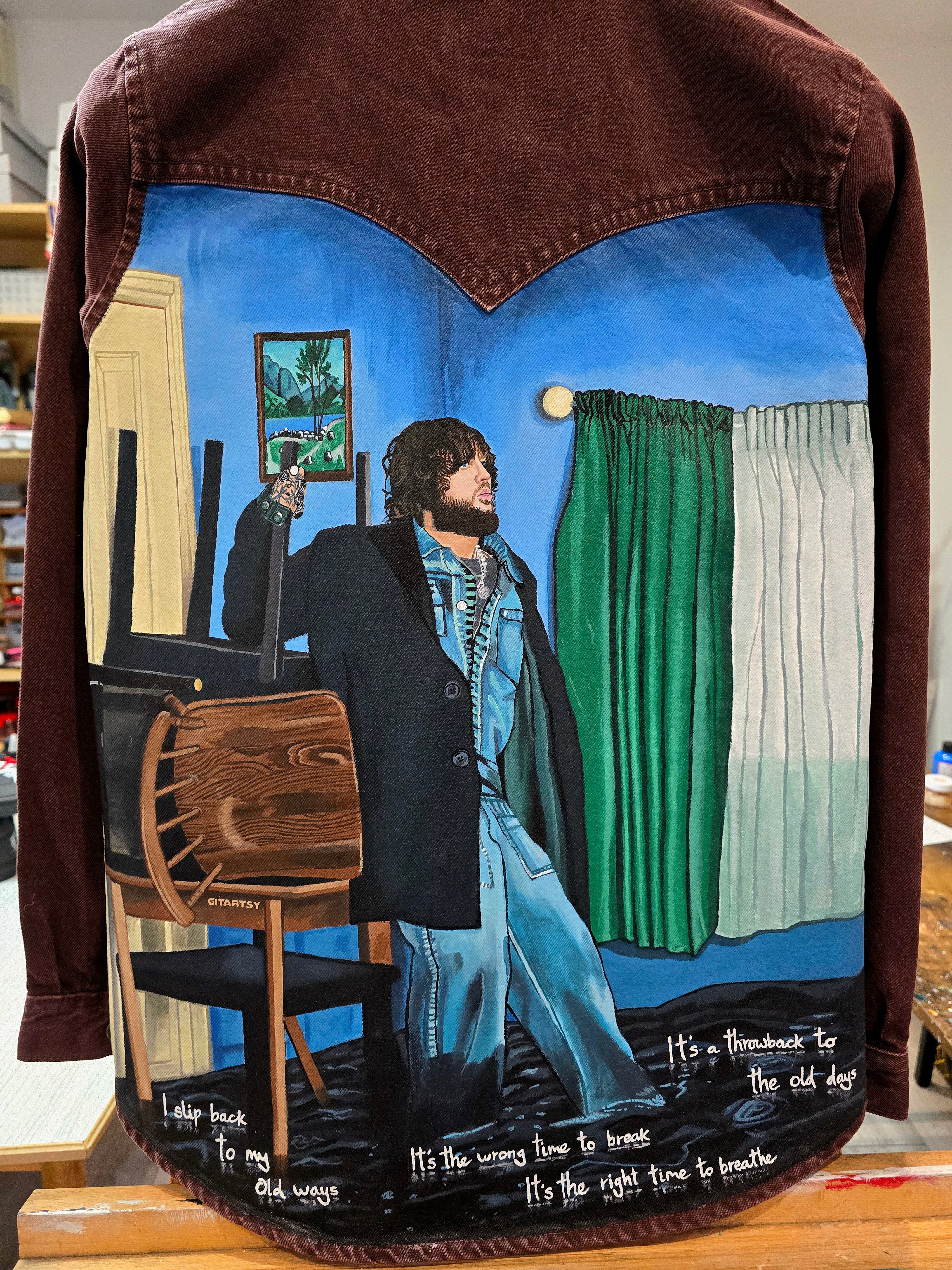 James Arthur Singer Hand Painted Denim Jacket featuring a detailed back artwork of James Arthur in a vibrant indoor scene, painted on a burgundy denim jacket with “Pisces” embroidered on the front, created by Gitartsy using high-quality fabric paints for long-lasting wear.

