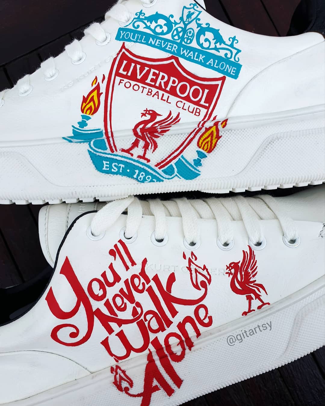 Custom Liverpool FC sneakers in white featuring hand-painted artwork with the club crest, Liverbird, “You’ll Never Walk Alone” slogan, and CHAMPIONS 20 detailing. Designed for Liverpool fans, these one-of-a-kind sneakers blend football passion with wearable art. Built on a durable white sole base with red and black accents, ideal for gifting or match day outfits.

