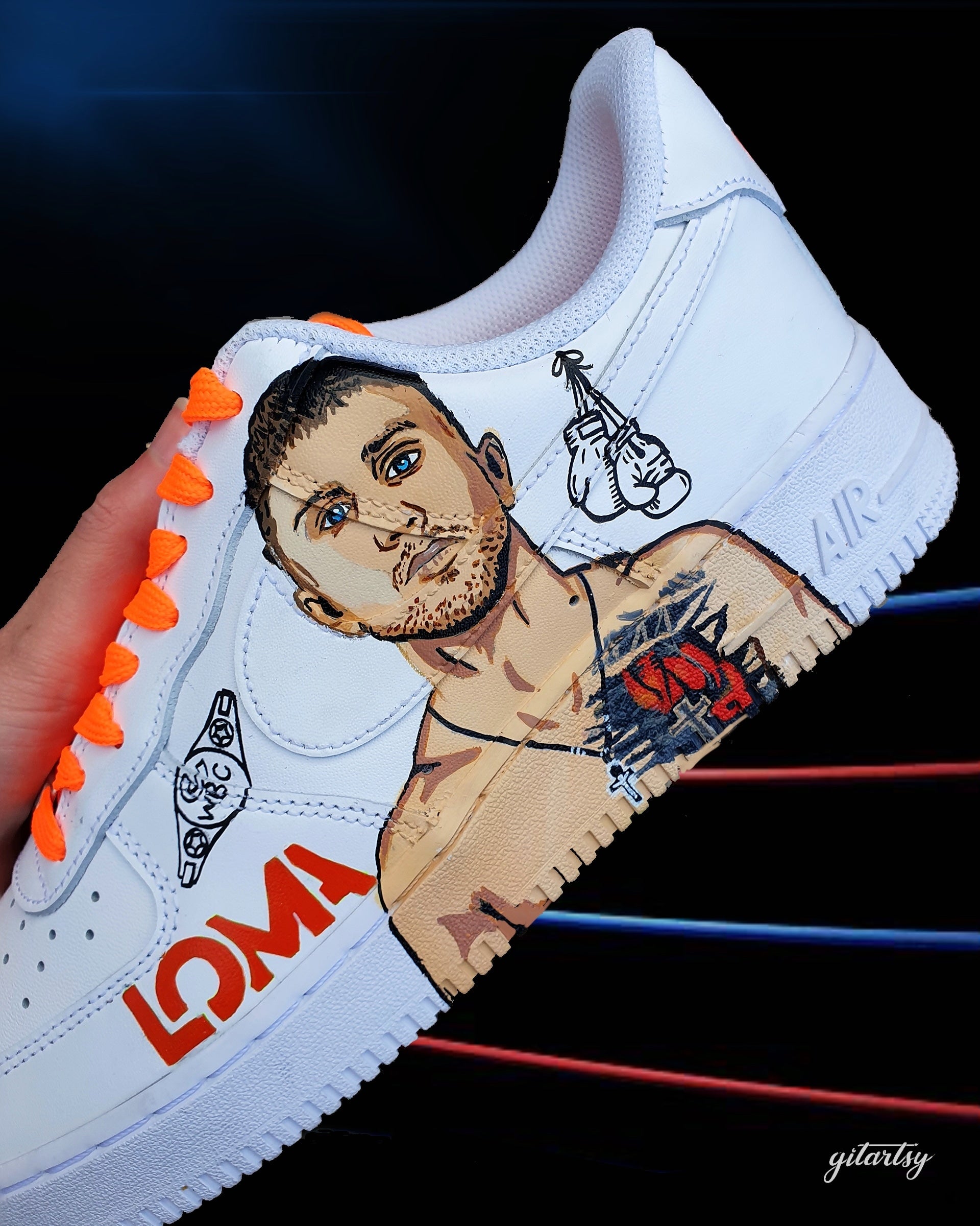 "Hand-painted Nike Air Force 1 sneakers featuring detailed portraits of boxing legends Muhammad Ali and Vasiliy Lomachenko, custom artwork with boxing gloves, quotes, and championship symbols, by Gitartsy."

