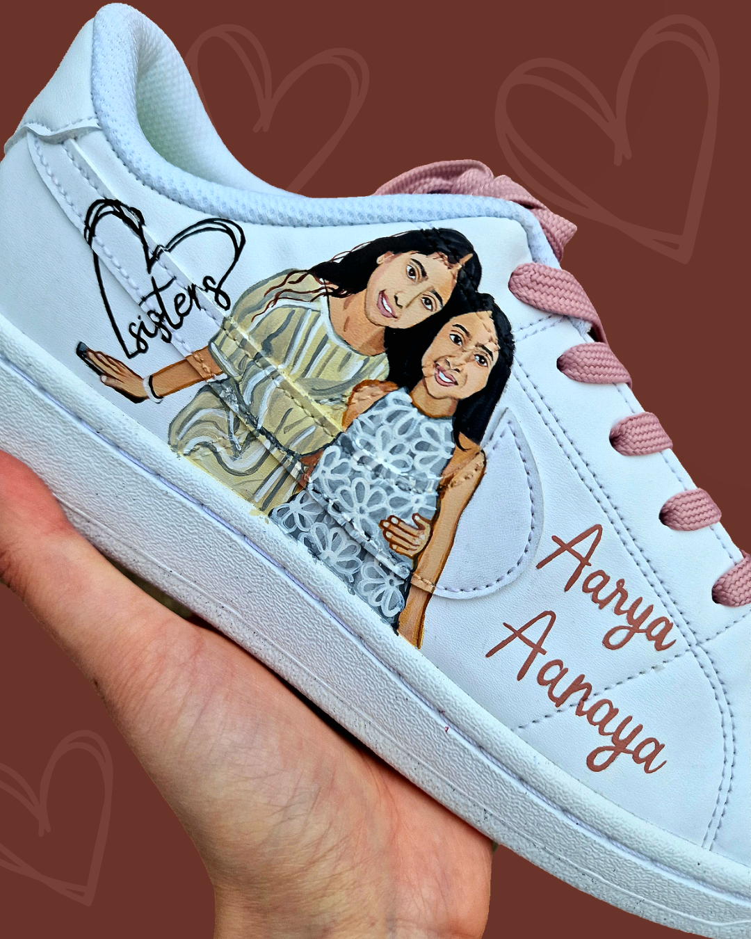Custom hand-painted Nike sneakers featuring a realistic portrait of a mother and her daughters, personalized names, floral details, and loving elements like “Mama” and “Ba.” Crafted in white leather with pink swooshes and laces, these shoes are a perfect Mother’s Day gift showcasing unique wearable art.

