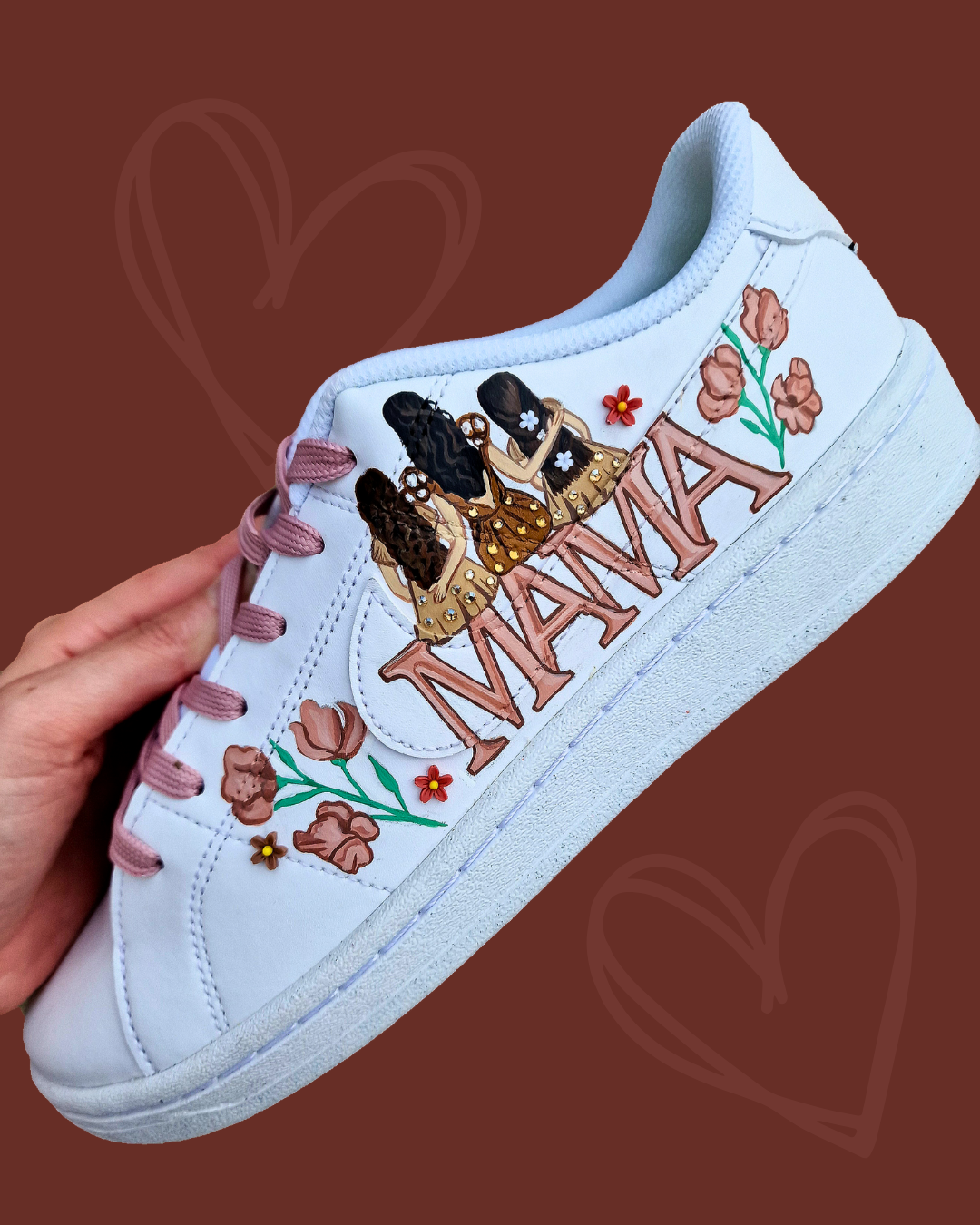 Custom hand-painted Nike sneakers featuring a realistic portrait of a mother and her daughters, personalized names, floral details, and loving elements like “Mama” and “Ba.” Crafted in white leather with pink swooshes and laces, these shoes are a perfect Mother’s Day gift showcasing unique wearable art.

