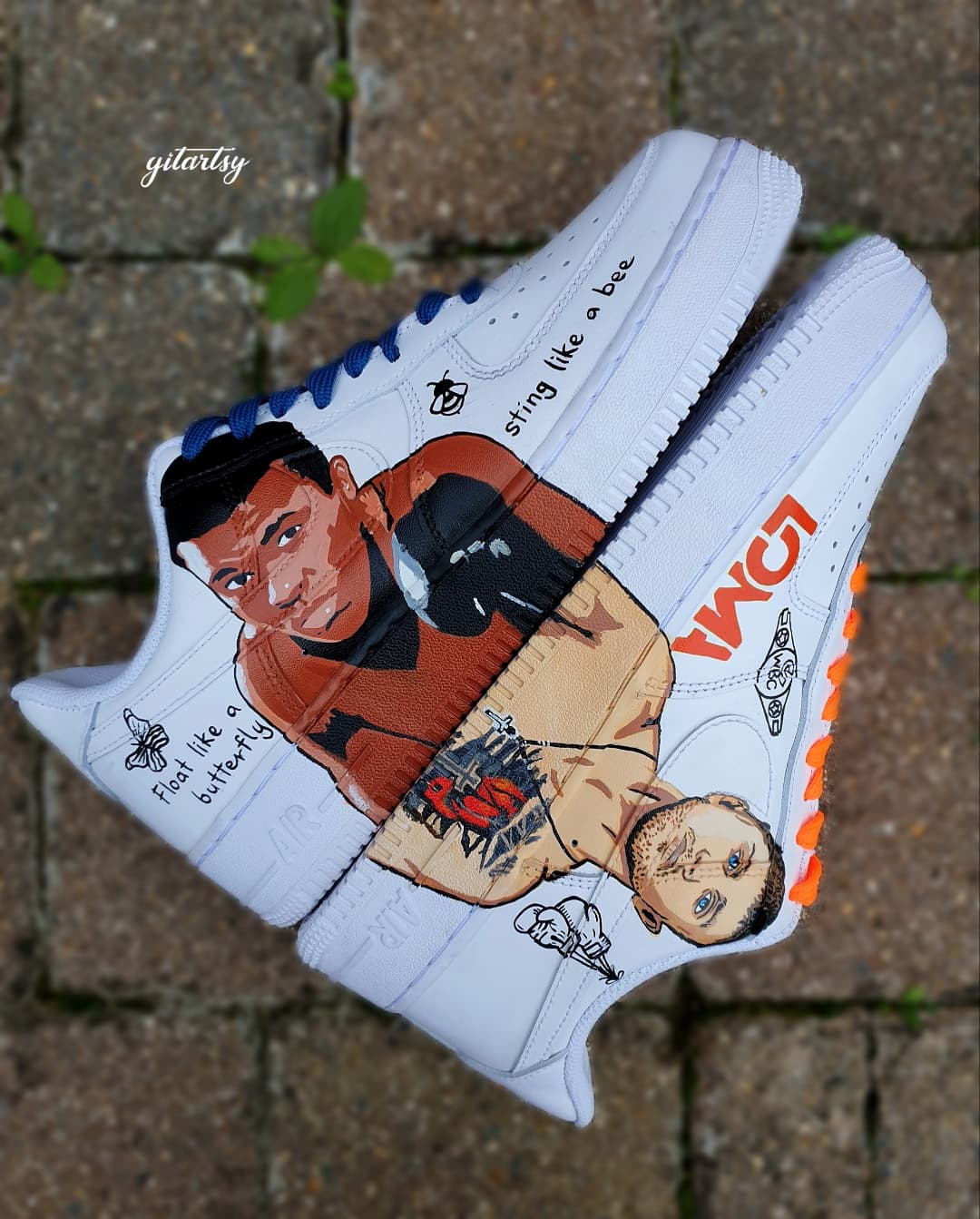 "Hand-painted Nike Air Force 1 sneakers featuring detailed portraits of boxing legends Muhammad Ali and Vasiliy Lomachenko, custom artwork with boxing gloves, quotes, and championship symbols, by Gitartsy."

