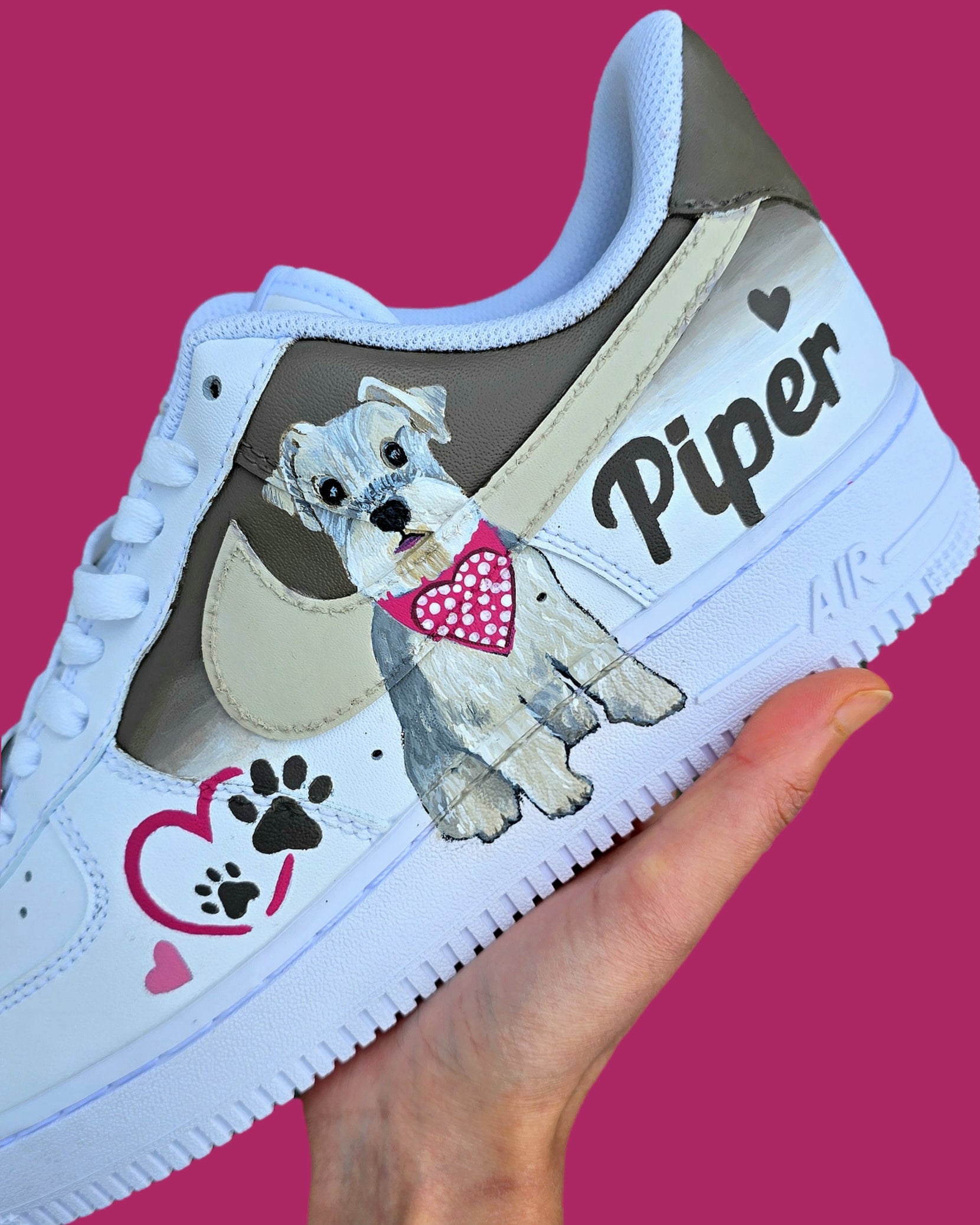 Hand-painted Nike Air Force 1 custom sneakers featuring a realistic pet portrait of “Piper” the dog 🐾, pink or taupe background, heart ❤️ and paw print accents, and personalised name detail, created by Gitartsy.

