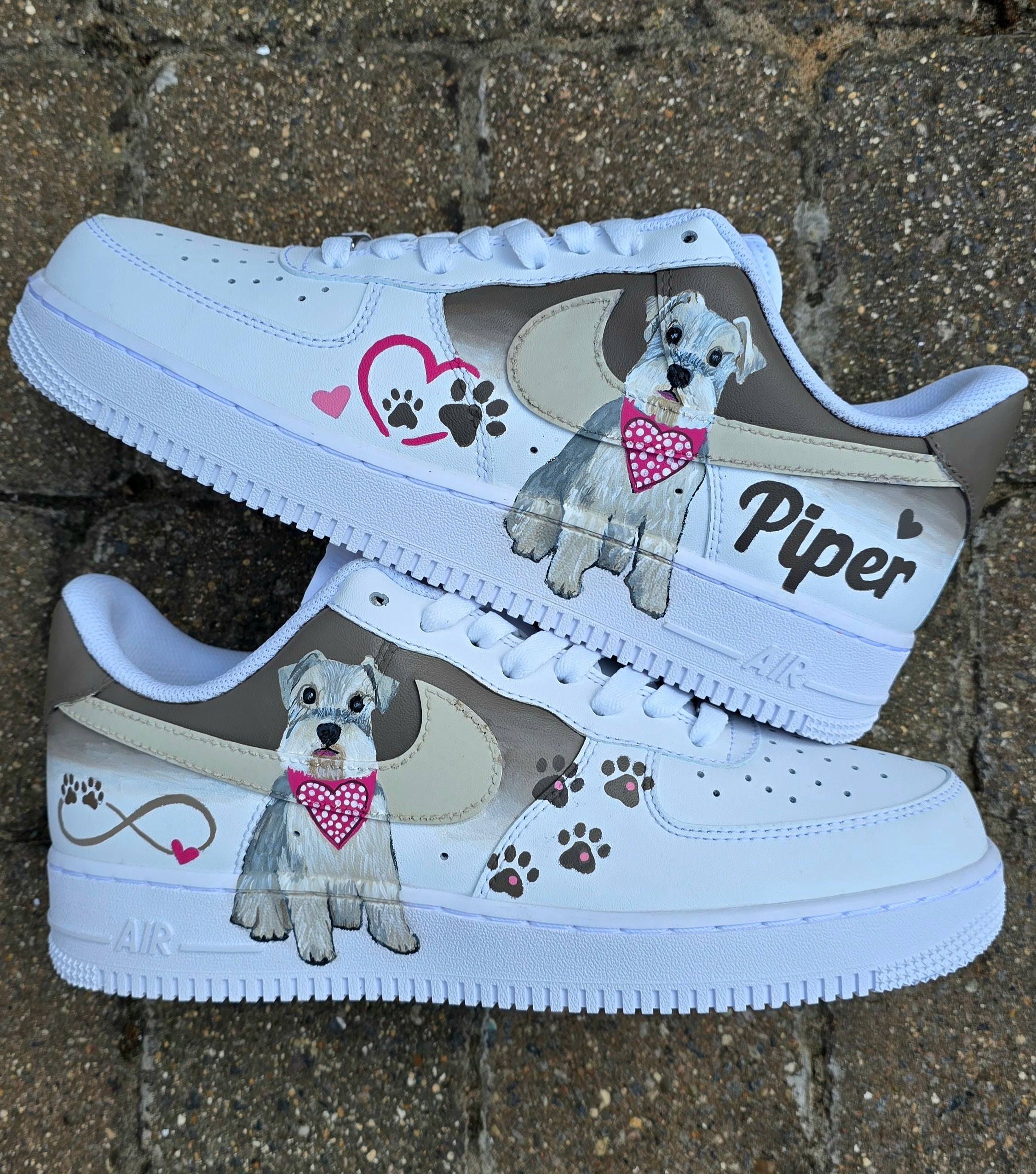 Hand-painted Nike Air Force 1 custom sneakers featuring a realistic pet portrait of “Piper” the dog 🐾, pink or taupe background, heart ❤️ and paw print accents, and personalised name detail, created by Gitartsy.

