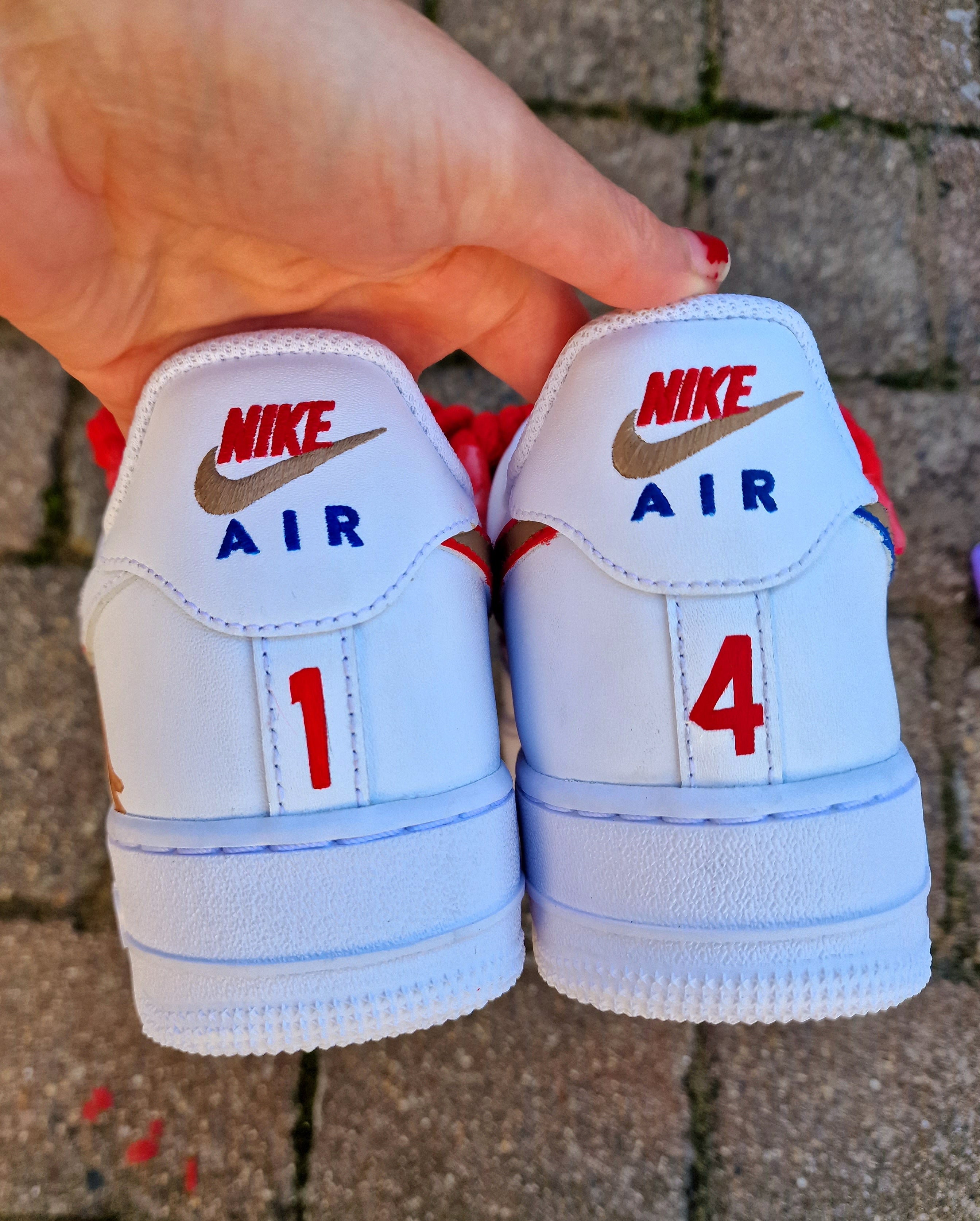 Hand-painted custom Nike Air Force 1 sneakers featuring Arsenal legend Thierry Henry, the Arsenal crest, Premier League trophy, and bold red laces. Perfect for Arsenal fans and football sneaker collectors.

