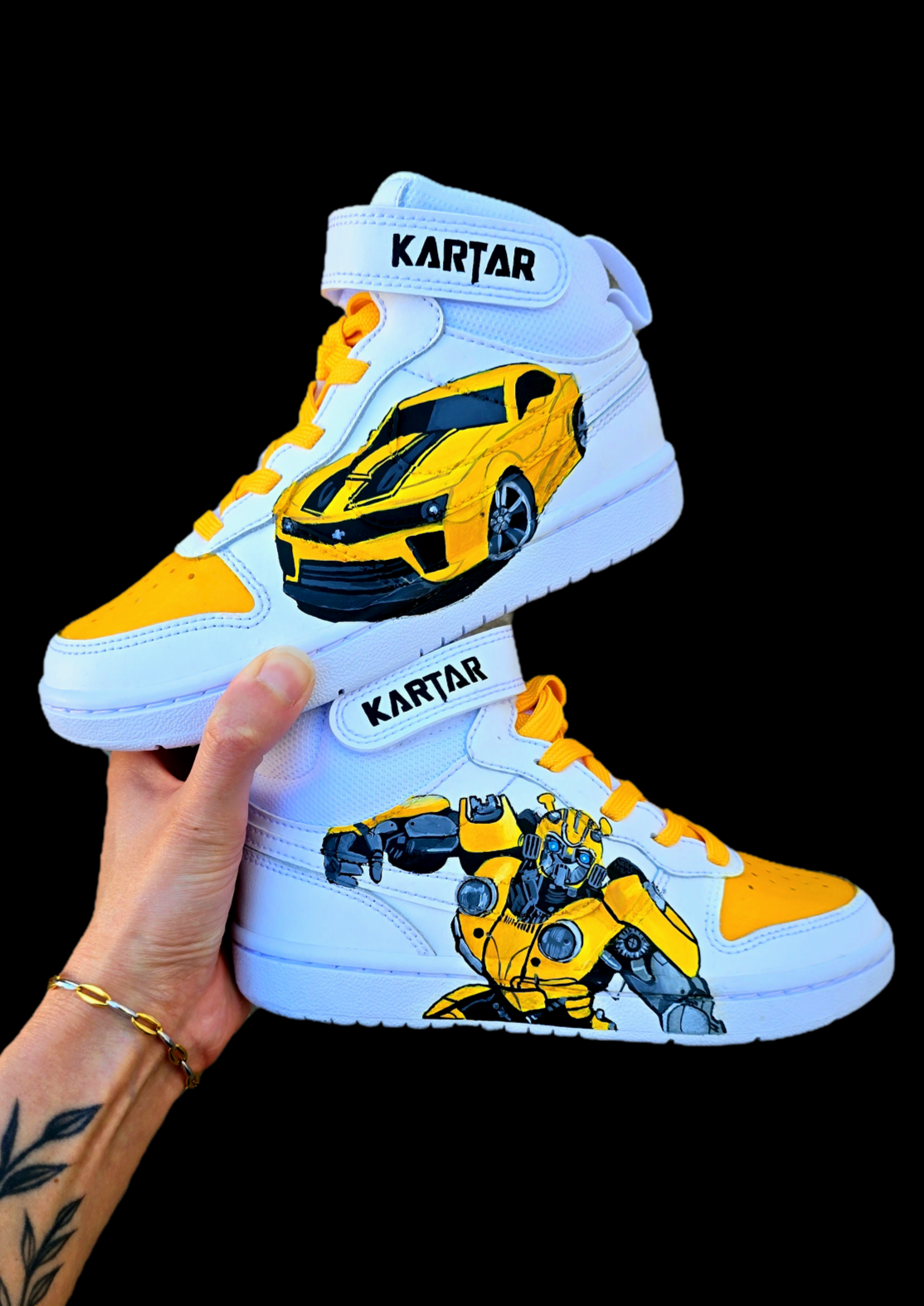 Custom hand-painted Nike AF1 sneakers for kids featuring vibrant Transformers Bumblebee artwork in both robot 🤖 and car 🚗 form. Designed with bright yellow, black, and metallic grey detailing, sealed with a waterproof finish for long-lasting wear. Perfect for young Transformers fans and collectors.

