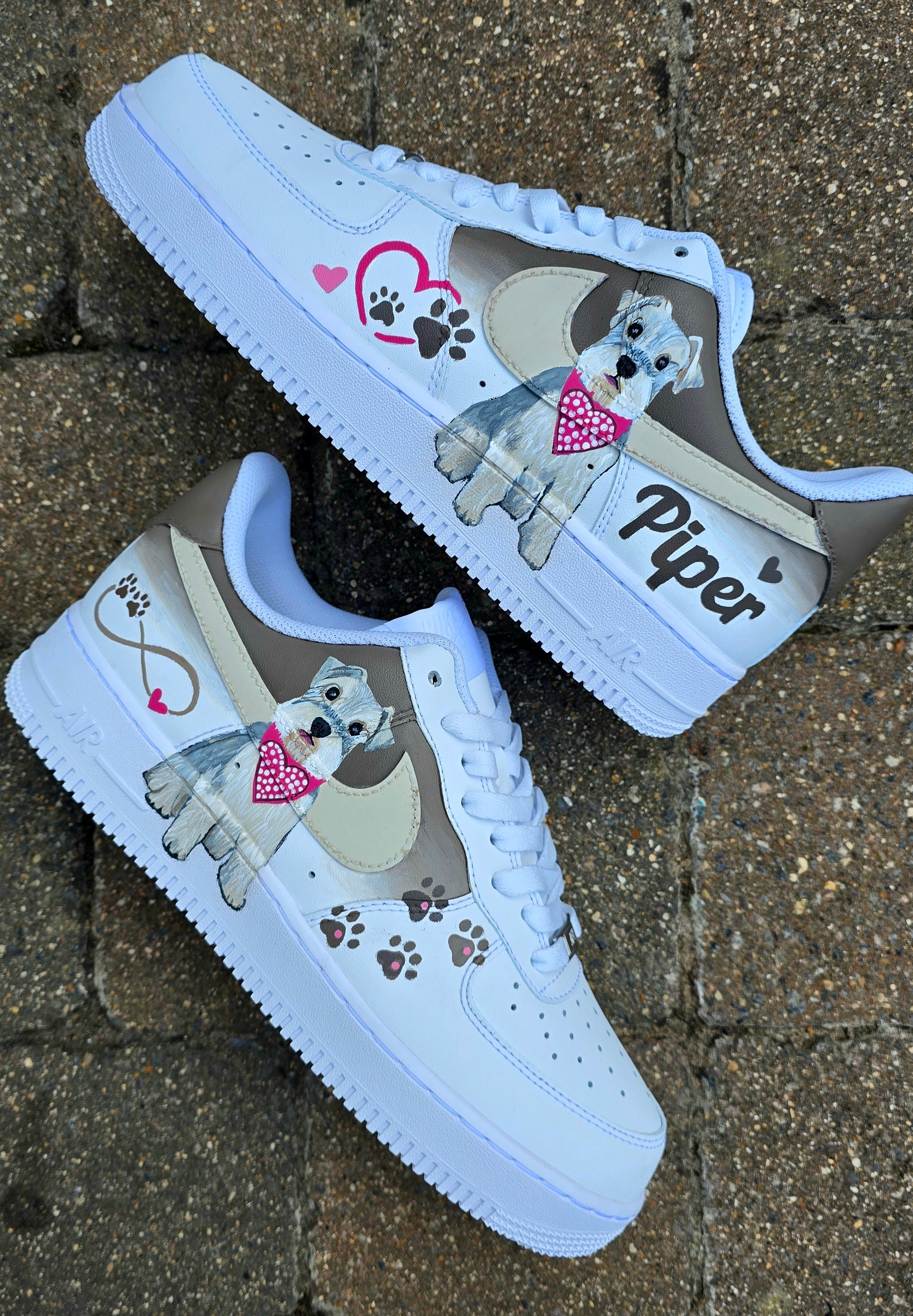 Hand-painted Nike Air Force 1 custom sneakers featuring a realistic pet portrait of “Piper” the dog 🐾, pink or taupe background, heart ❤️ and paw print accents, and personalised name detail, created by Gitartsy.

