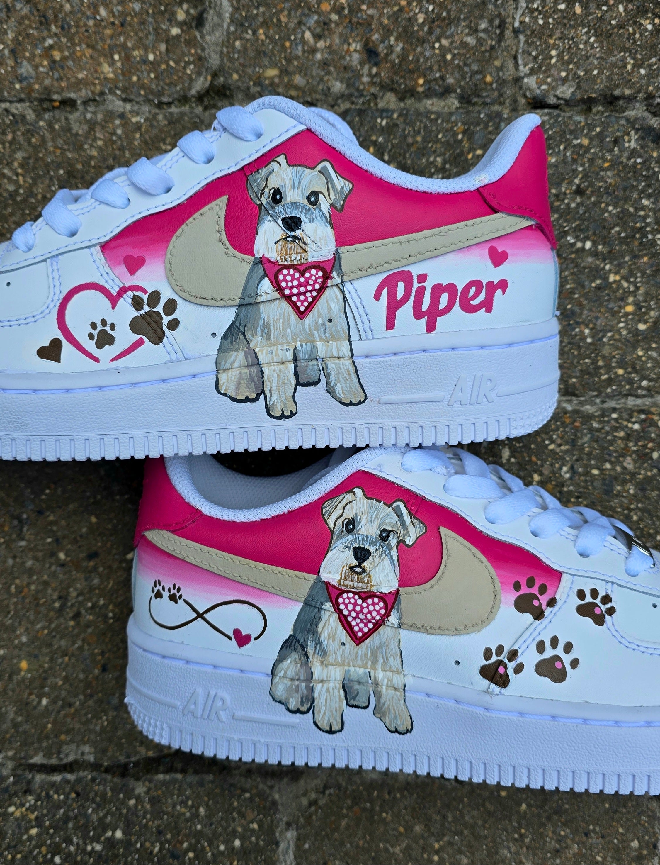 Hand-painted Nike Air Force 1 custom sneakers featuring a realistic pet portrait of “Piper” the dog 🐾, pink or taupe background, heart ❤️ and paw print accents, and personalised name detail, created by Gitartsy.

