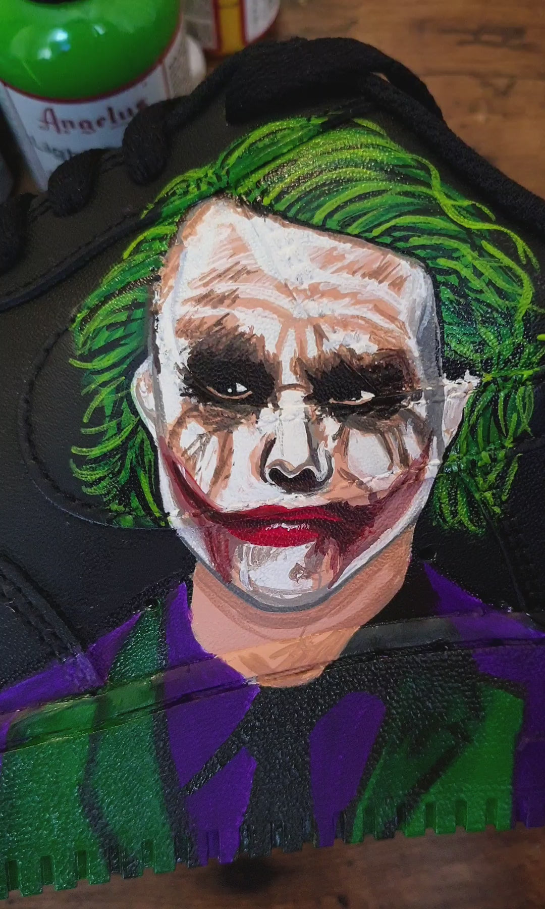Batman and Joker portraits painted on black Nike AF1 sneakers with 'why so serious' written on them - neon