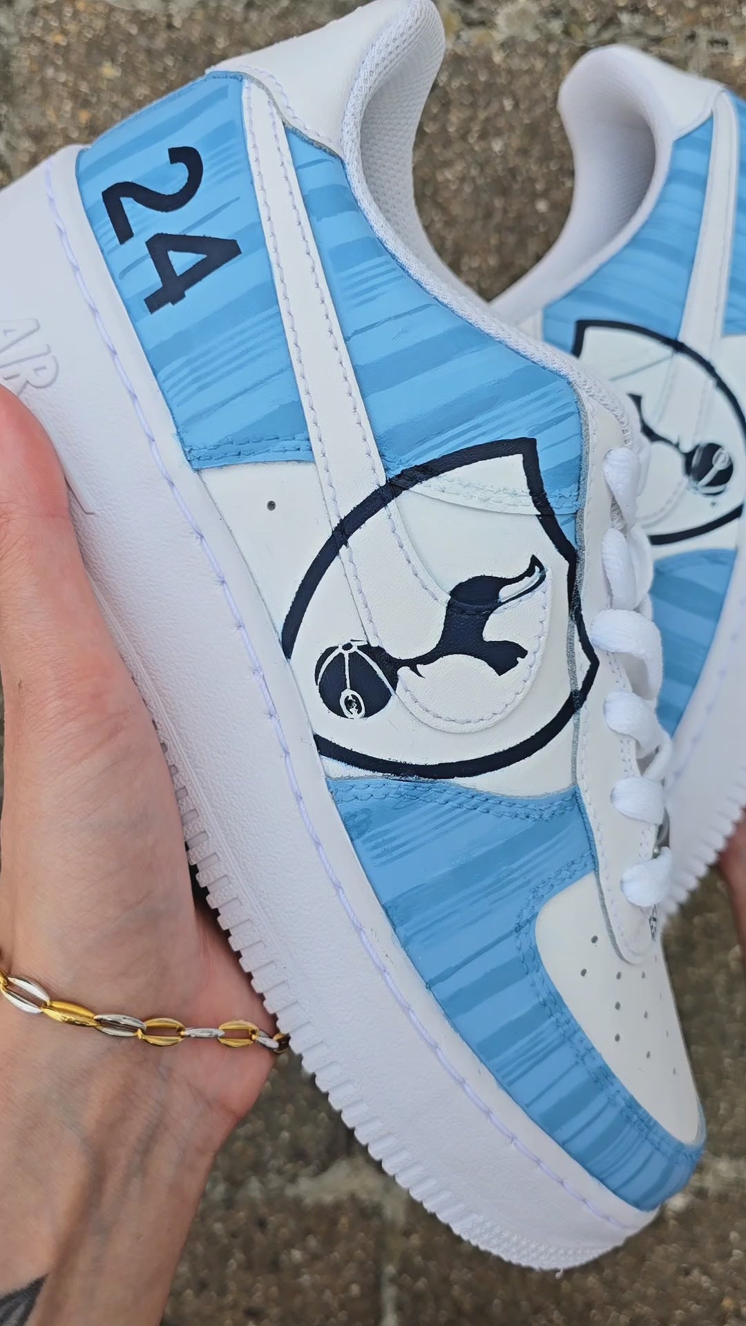 Custom hand-painted Nike Air Force 1 sneakers featuring Tottenham Hotspur-inspired design with blue stripes, the Spurs logo, and personalised number "24" – football-themed streetwear by Gitartsy.